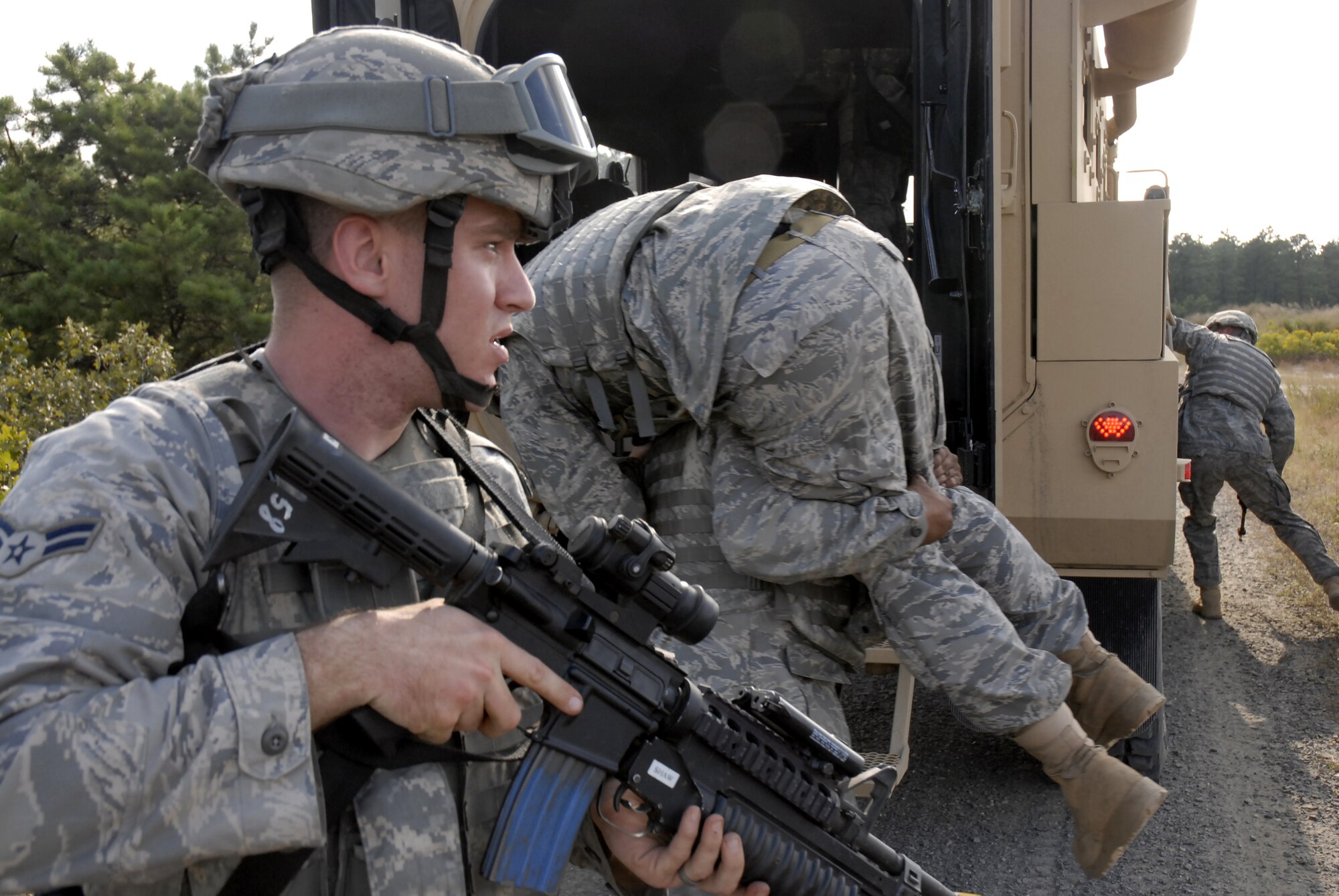 A security forces Airman provides security for the movement of injured personnel after a vehicle was disabled by a simulated explosion of an improvised explosive device during a pre-deployment training exercise conducted by the U.S. Air Force Expeditionary Center's 421st Combat Training Squadron at Joint Base McGuire-Dix-Lakehurst, N.J. on September 15, 2009.  (U.S. Air Force photo/Tech. Sgt. Paul R. Evans)