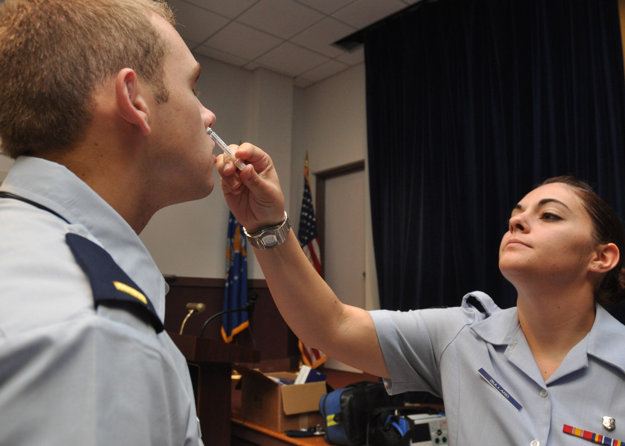 Airman 1st Class Amberle Bullard, 96th Surgical Operations Squadron, administers the flu-mist vaccination to an active duty member at Bldg. 439 Sept. 21.  Flu vaccinations will be given all week to active-duty members from 6 a.m. to 6 p.m.  (U.S. Air Force photo/Airman 1st Class Chris Jacobs)