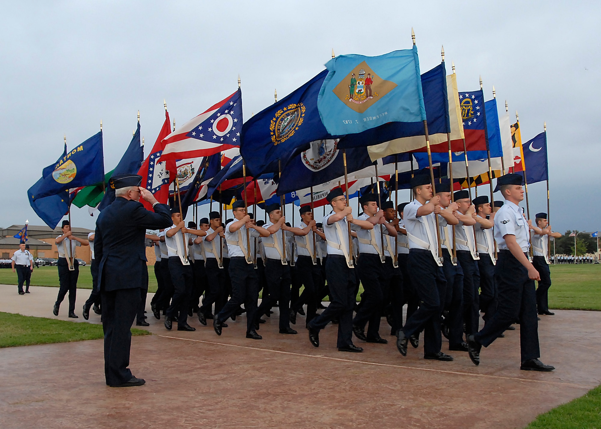 Retired Air Force Col. Richard Mac Isaac, the reviewing officer at the Prisoner of War and Missing in Action Recognition Day parade, salutes the flags and Airmen as they pass Sept. 18. Sheppard observed all the sacrifices POWs and MIA troops during the parade, a wreath laying ceremony and a luncheon. (U.S. Air Force photo/Harry Tonemah)