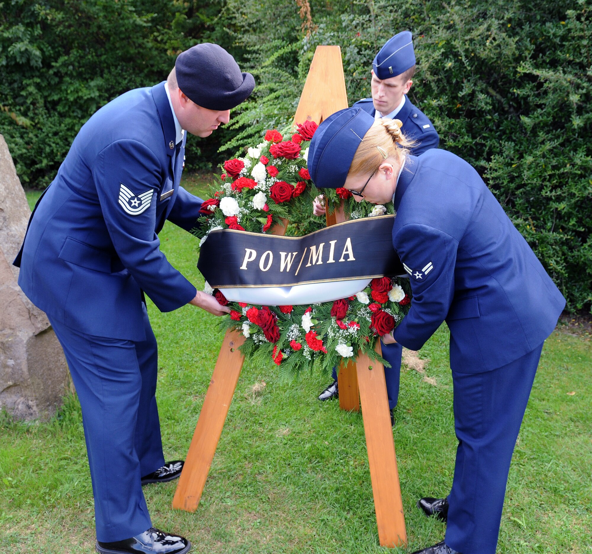 SPANGDAHLEM AIR BASE, Germany -- Tech. Sgt. Eric Brown, 52nd Security Forces Squadron, Airman 1st Class Christina Peabody, 52nd Medical Operations Squadron, and 1st Lt. Andrew Williams, 52nd Operations Support Squadron, lay a wreath during the POW/MIA ceremony at the Air Park Sept. 18. The wreath was laid to honor and remember servicemembers listed as prisoners of war or missing in action. (U.S. Air Force photo/Airman 1st Class Nathanael Callon)