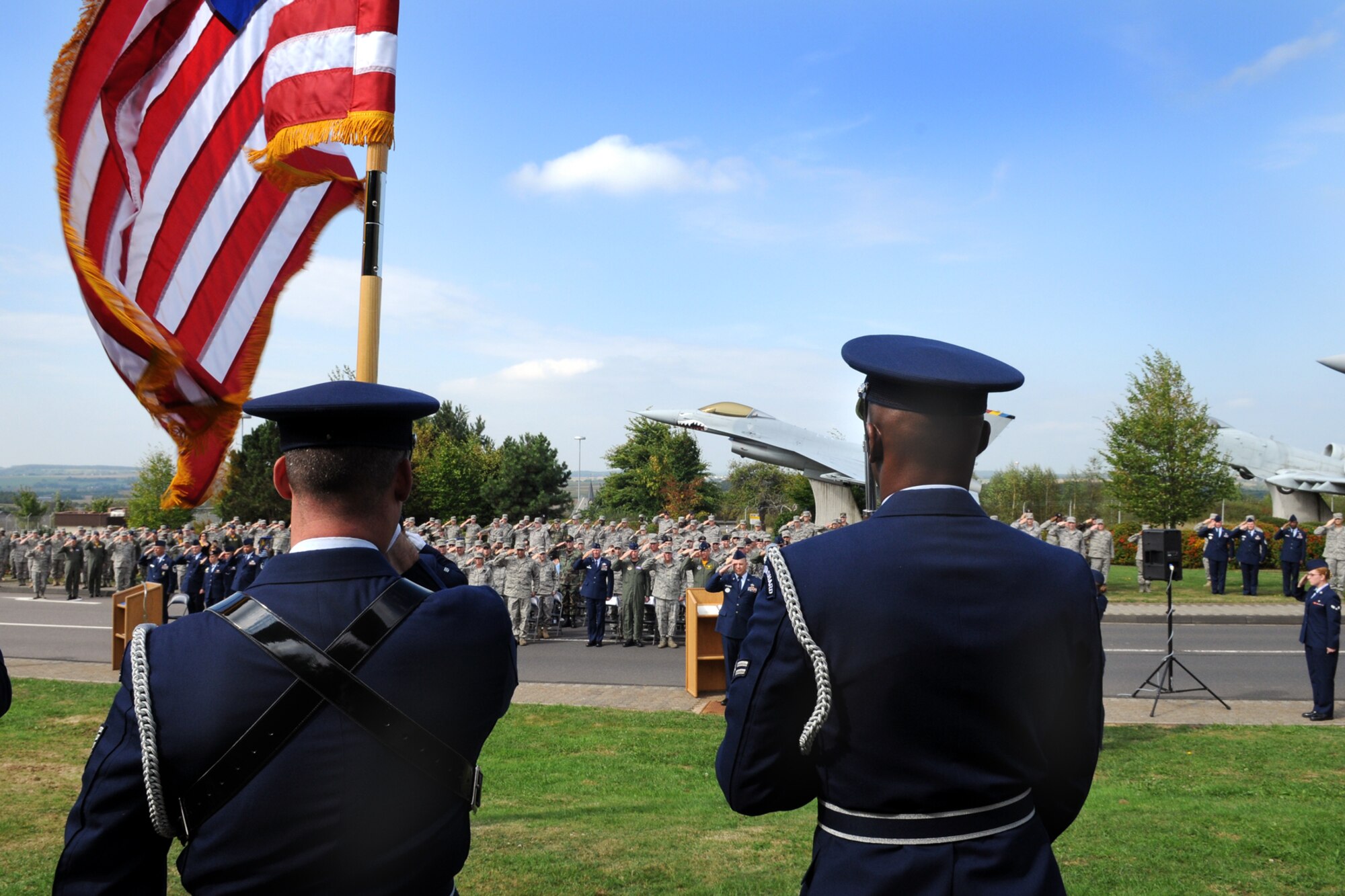 SPANGDAHLEM AIR BASE, Germany -- Members of the 52nd Fighter Wing Honor Guard post the colors as members of the 52nd FW salute during the POW/MIA ceremony at the Air Park Sept. 18. The ceremony is held every year to remember those who have served and been taken prisoners of war or have been listed as missing in action. (U.S. Air Force photo/Airman 1st Class Nathanael Callon)