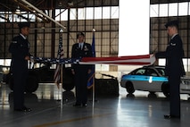 SEYMOUR JOHNSON AIR FORCE BASE, N.C. -- Maj. Jeff Poupart (center), stands proudly during the flag folding ceremony held during his retirement on Sept. 13. Maj. Poupart served more than 25 years and ended his military career as commander of the 916th Security Forces Squadron. U.S. Air Force photo by: TSgt. Scotty Sweatt, 916ARW/PA.