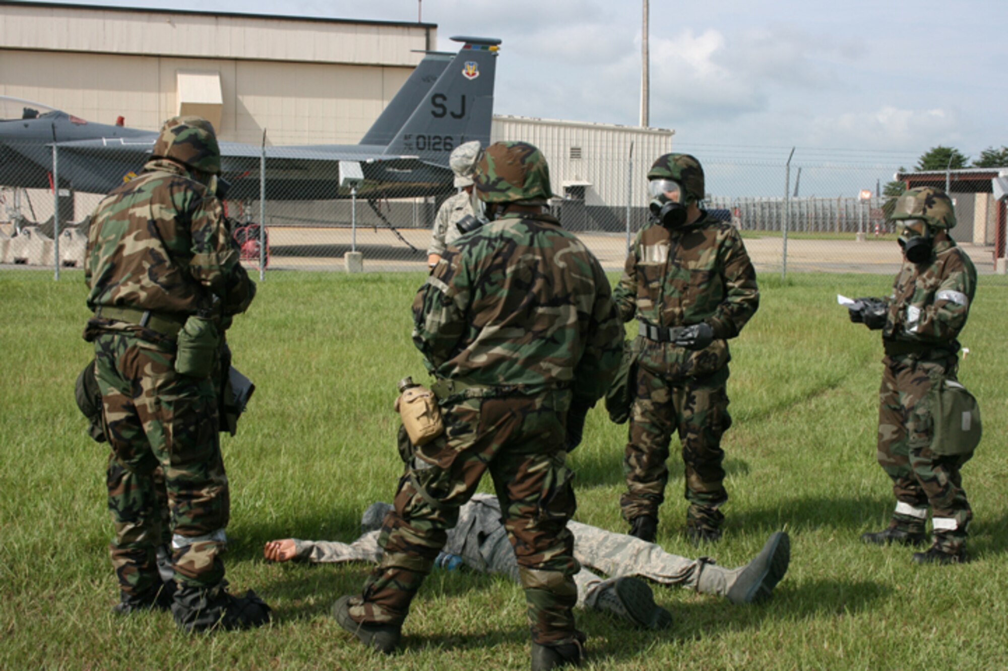 SEYMOUR JOHNSON AIR FORCE BASE, N.C. -- Members of the 916th Communication Squadron practice self-aid and buddy care in preparation for major exercises at the wing in 2010 and 2011. Here, members are dressed in full chemical protective equipment and are practicing wartime scenarios. Currently the wing is scheduled for exercises in June and October 2010 with its Operational Readiness Inspection set for late January 2011.