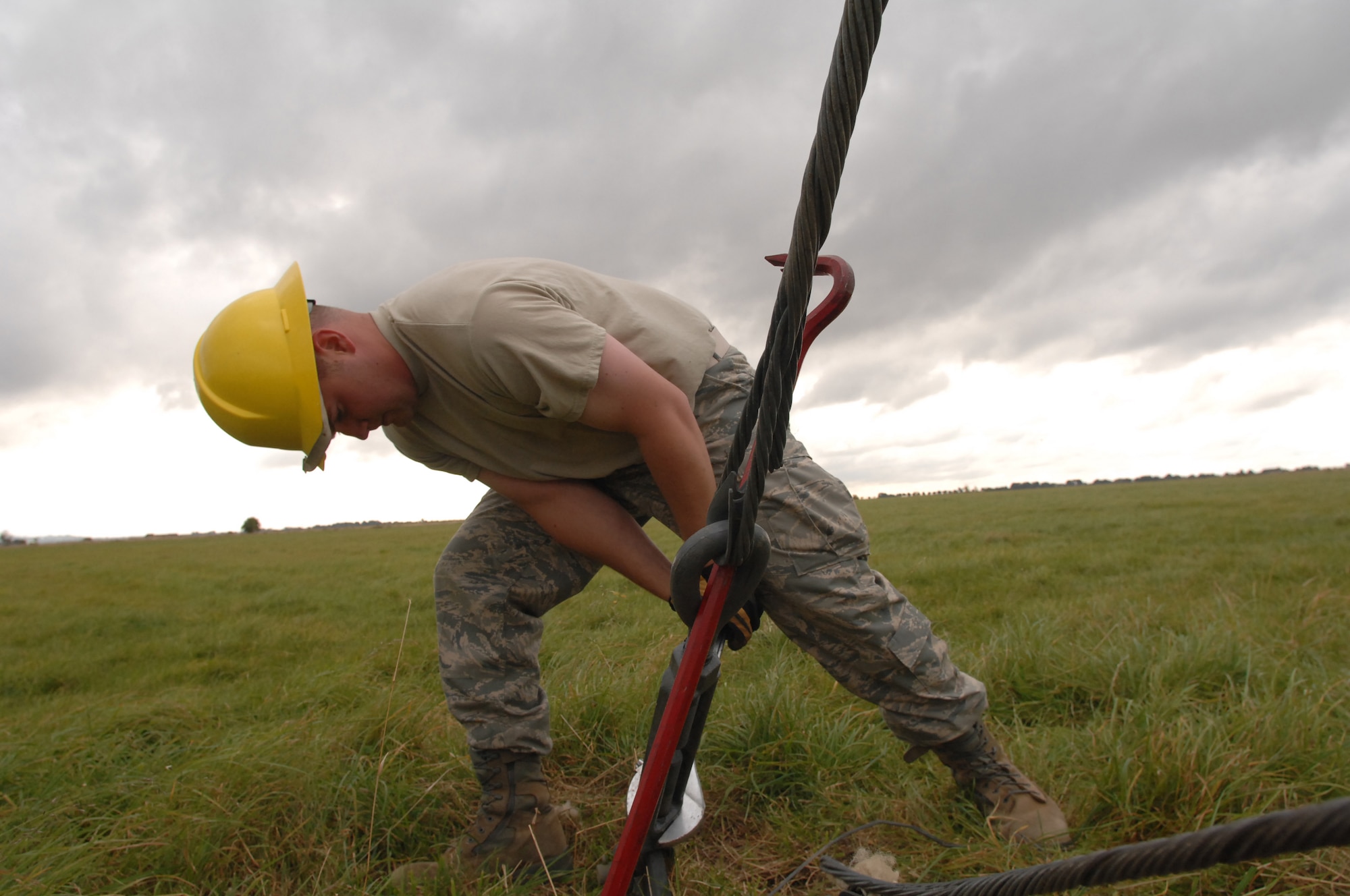 U.S. Air Force Staff Sgt. Scot Craig, 1st Communications Maintenance Squadron, loosens a guywire, which holds tension through tie-down points connected to a radio tower. Sergeant Craig is a member of the Cable and Antenna Theater Maintenance Team, who travel routinely throughout Europe maintaining the communications capability force across the Atlantic and on into the European Route. (U.S. Air Force photo by Tech. Sgt. Michael Voss)