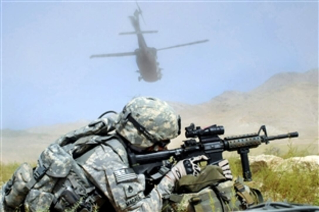 U.S. Army Staff Sgt. Francis Macale secures a landing zone as his transportation, a UH-60 Blackhawk helicopter, flies away near the Koh Band district of Kapisa province, Afghanistan,
Sept. 14, 2009. Macale is a squad leader assigned to the Kapisa Provincial Reconstruction Team.