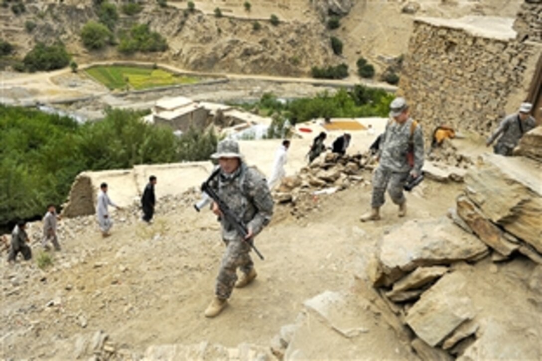 U.S. troops walk up a mountain during a visit to Afghan beekeepers in the Dara district of Panjshir, Afghanistan, Sept. 7, 2009. The stroops are assigned to the Panjshir Provincial Reconstruction Team. The program, sponsored by the Panjshir Ministry of Agriculture, began in July, 2008, with the delivery of 900 hives.