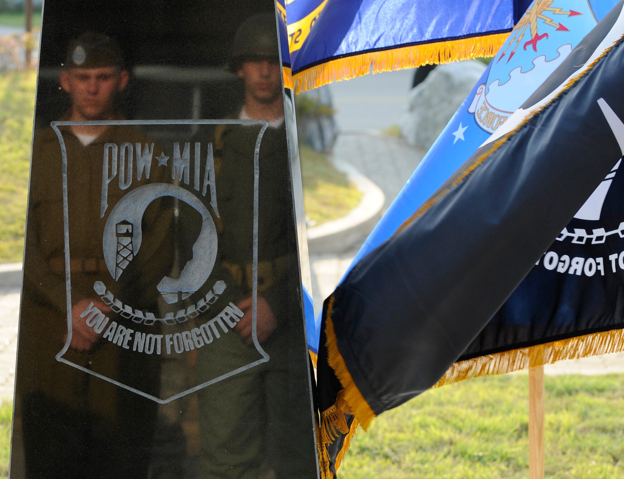 Soldiers, wearing historical military uniforms, are seen in the reflection of the POW/MIA statute during the POW/MIA remembrance ceremony in front of the Osan Air Base theater Sept. 18. (U.S. Air Force photo/Senior Airman Stephenie Wade)