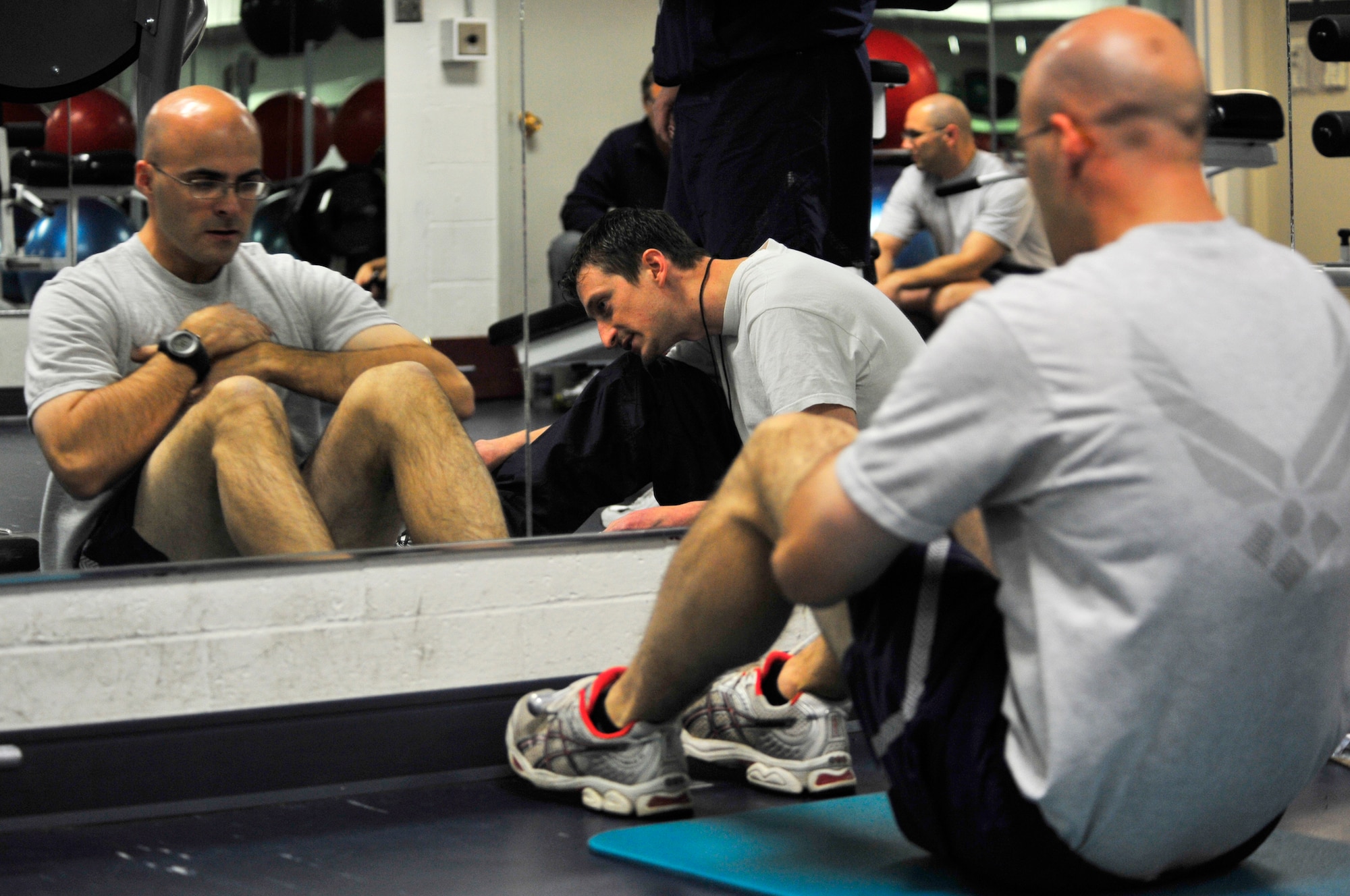 Michael Consalow counts sit ups performed by Staff Sgt. James Stewart at the Baker Field House Sept. 22, 2009, Eielson Air Force, Base, Alaska. The Fitness Center and the Health and Wellness Center staff provide many health activities and events available to the base population. Mr. Consalow is a physical training tester at the HAWC and Sergeant Stewart is a broadcaster assigned to the 354th Fighter Wing.(U.S. Air Force photo/Staff Sgt. Christopher Boitz)