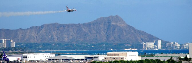 HICKAM AIR FORCE BASE, Hawaii -- Diamond Head and Waikiki provide a scenic background for the Thunderbirds, U.S. Air Force Demonstration Squadron, performance over Hickam Air Force Base, Hawaii, during the "Wings Over the Pacific," Open House Sept. 19 before a crowd of more than 42,000. The Thunderbirds demonstrate the capabilities the F-16 Fighting Falcon by performing combat maneuvers during their aerial demonstration. This is Hickam's first open house since 2003, and a crowd of nearly 100,000 paid a visit during the weekend. (U.S. Air Force photo/Staff Sgt. Mike Meares)