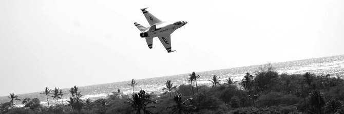 HICKAM AIR FORCE BASE, Hawaii -- A Thunderbird races over Hickam?s show center and out over the Pacific during the U.S. Air Force Demonstration Squadron?s performance at the "Wings Over the Pacific," Open House Sept. 19 before a crowd of more than 42,000. The Thunderbirds demonstrate the capabilities the F-16 Fighting Falcon by performing combat maneuvers during their aerial demonstration. This is Hickam's first open house since 2003, and a crowd of nearly 100,000 paid a visit during the weekend. (U.S. Air Force photo/Staff Sgt. Mike Meares)