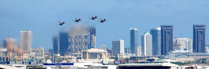 HICKAM AIR FORCE BASE, Hawaii -- The Honolulu skyline rises into the playground of the Thunderbirds, U.S. Air Force Demonstration Squadron, as they take to flight to perform over Hickam Air Force Base, Hawaii, during the "Wings Over the Pacific," Open House Sept. 19 before a crowd of more than 42,000. The Thunderbirds demonstrate the capabilities the F-16 Fighting Falcon by performing combat maneuvers during their aerial demonstration. This is Hickam's first open house since 2003, and a crowd of nearly 100,000 paid a visit during the weekend. (U.S. Air Force photo/Staff Sgt. Mike Meares)