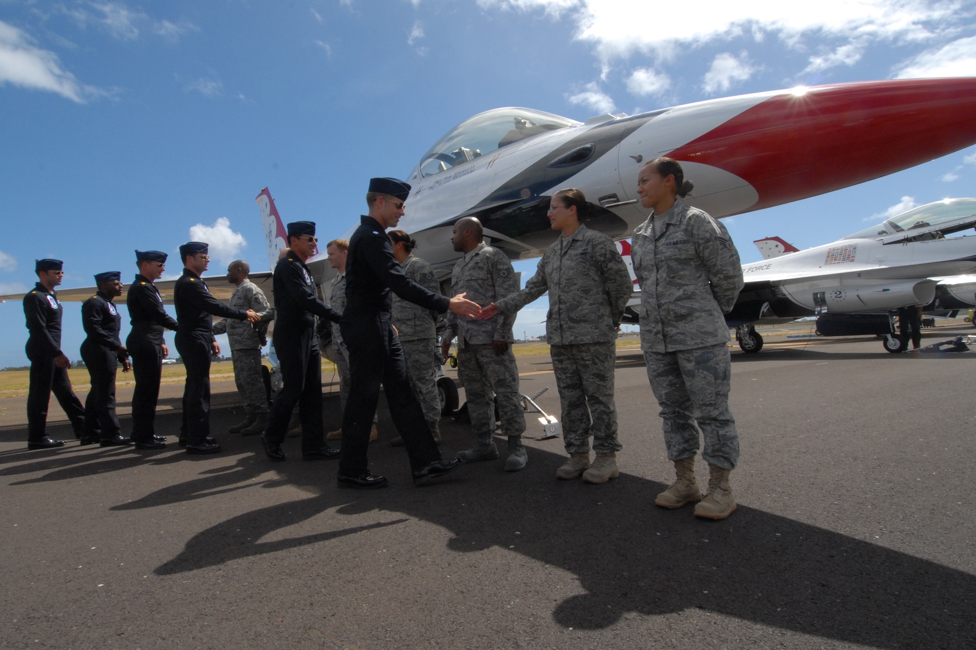 HICKAM AIR FORCE BASE, Hawaii - Thunderbird pilots congratulate Airmen who reenlisted into the Air Force prior to the Thunderbirds taking to the skies Sept. 18. The Airmen who reenlisted were: Senior Master Sgt. Orville White, Staff Sgt. Travis Dixon, Staff Sgt. Ehtan Ervin, Staff Sgt. Casey Hanson, Staff Sgt. Mary Kimberly, Staff Sgt. Charles Nelson and Senior Airman Elyana Soto. They reenlisted on the Air Force's 62nd birthday. Friends and family members were a planeside to witness the event. (U.S. Air Force photo/Staff Sgt. Mike Meares)