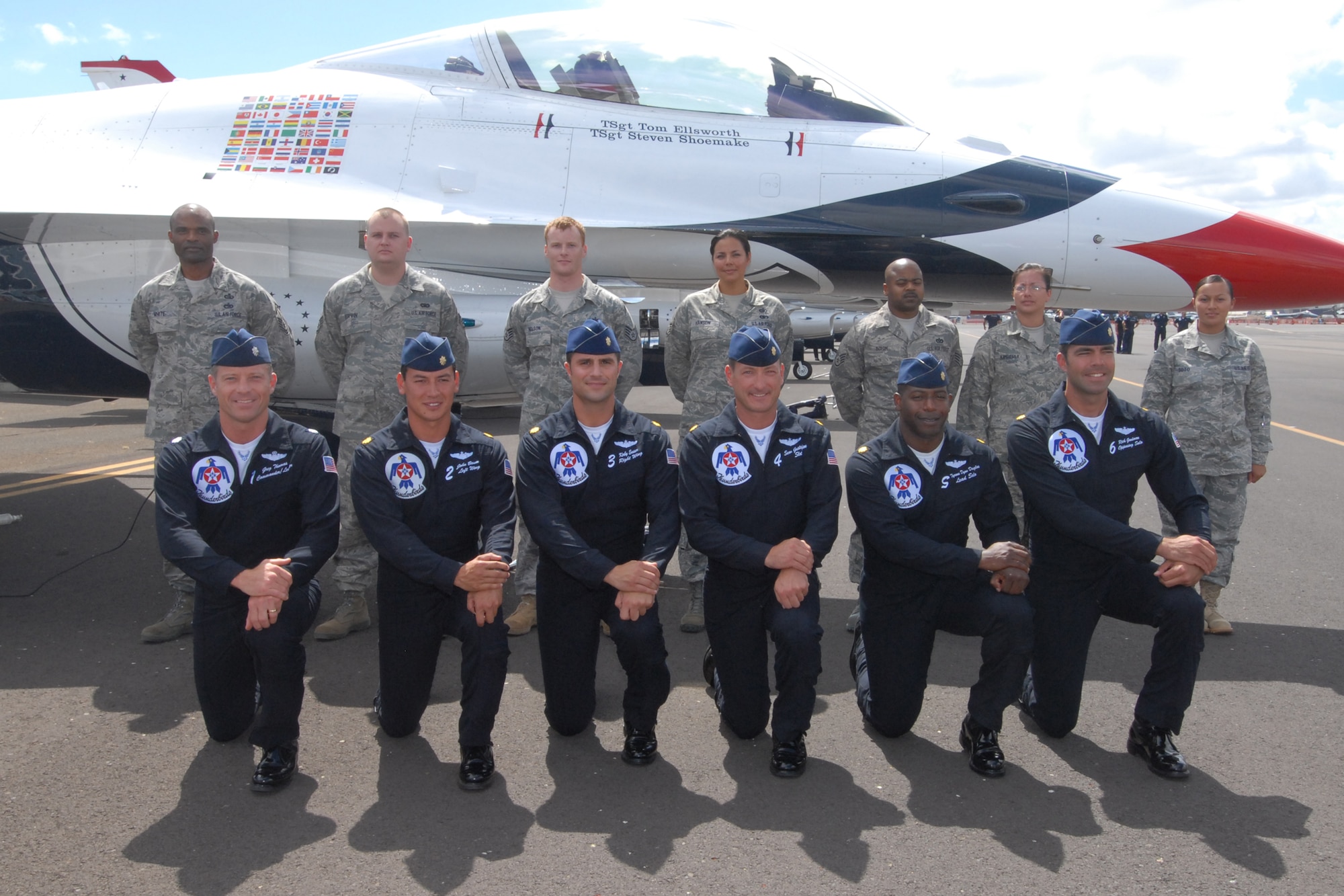 HICKAM AIR FORCE BASE, Hawaii - Thunderbird pilots pose in front of Airmen who reenlisted into the Air Force prior to the Thunderbirds taking to the skies Sept. 18. The Airmen who reenlisted were: Senior Master Sgt. Orville White, Staff Sgt. Travis Dixon, Staff Sgt. Ehtan Ervin, Staff Sgt. Casey Hanson, Staff Sgt. Mary Kimberly, Staff Sgt. Charles Nelson and Senior Airman Elyana Soto. They reenlisted on the Air Force's 62nd birthday. Friends and family members were a planeside to witness the event. (U.S. Air Force photo/Staff Sgt. Mike Meares)