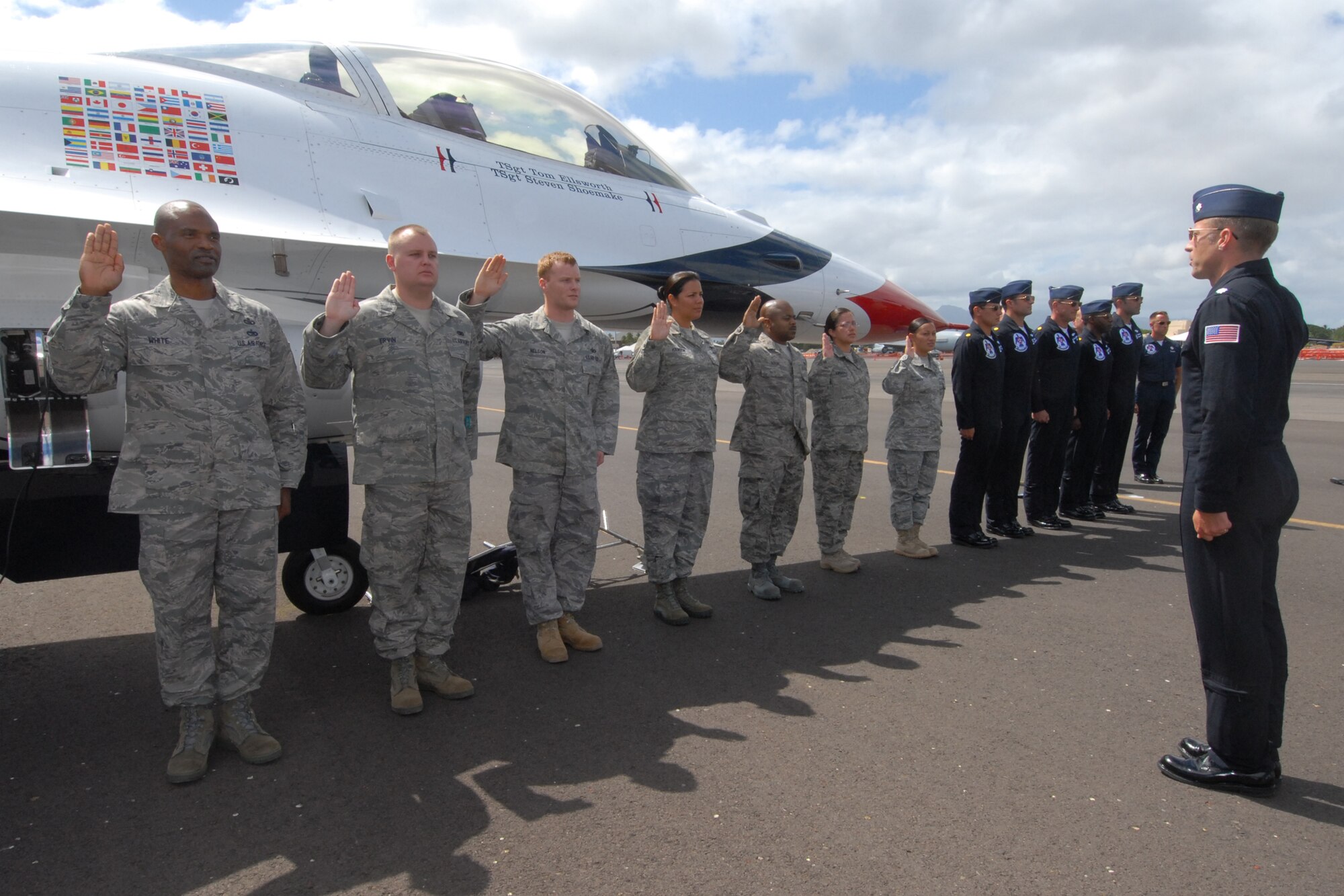 HICKAM AIR FORCE BASE, Hawaii -- Lt. Col. Greg Thomas, U.S. Air Force Thunderbird #1 Commander, reenlists Airmen into the Air Force Sept. 18 prior to the Thunderbirds taking to the skies. The Airmen who reenlisted were: Senior Master Sgt. Orville White, Staff Sgt. Travis Dixon, Staff Sgt. Ehtan Ervin, Staff Sgt. Casey Hanson, Staff Sgt. Mary Kimberly, Staff Sgt. Charles Nelson and Senior Airman Elyana Soto. They reenlisted on the Air Force's 62nd birthday. (U.S. Air Force photo/Staff Sgt. Mike Meares)