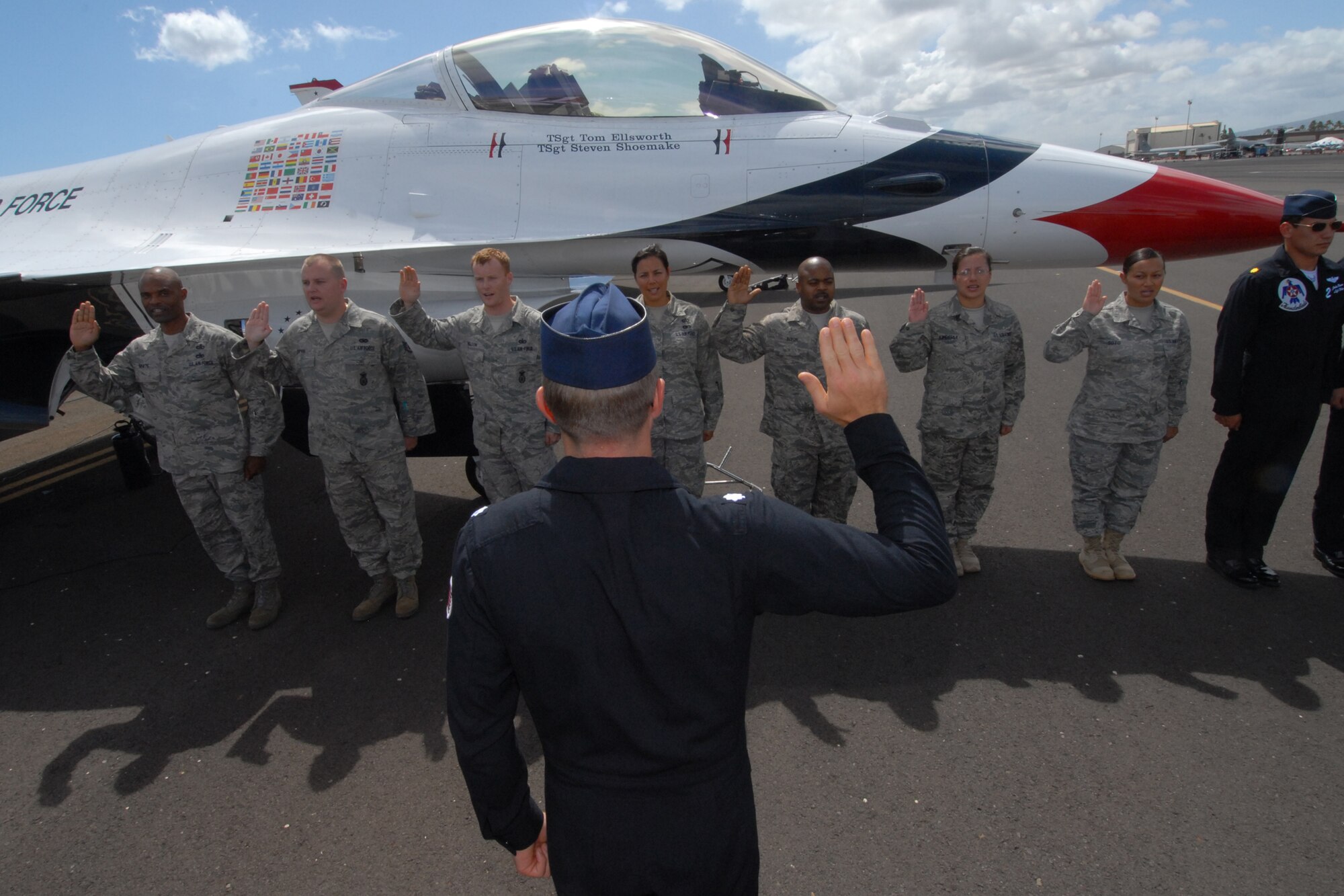 HICKAM AIR FORCE BASE, Hawaii -- Lt. Col. Greg Thomas, U.S. Air Force Thunderbird #1 Commander, reenlists Airmen into the Air Force Sept. 18 prior to the Thunderbirds taking to the skies. The Airmen who reenlisted were: Senior Master Sgt. Orville White, Staff Sgt. Travis Dixon, Staff Sgt. Ehtan Ervin, Staff Sgt. Casey Hanson, Staff Sgt. Mary Kimberly, Staff Sgt. Charles Nelson and Senior Airman Elyana Soto. They reenlisted on the Air Force's 62nd birthday. (U.S. Air Force photo/Staff Sgt. Mike Meares)