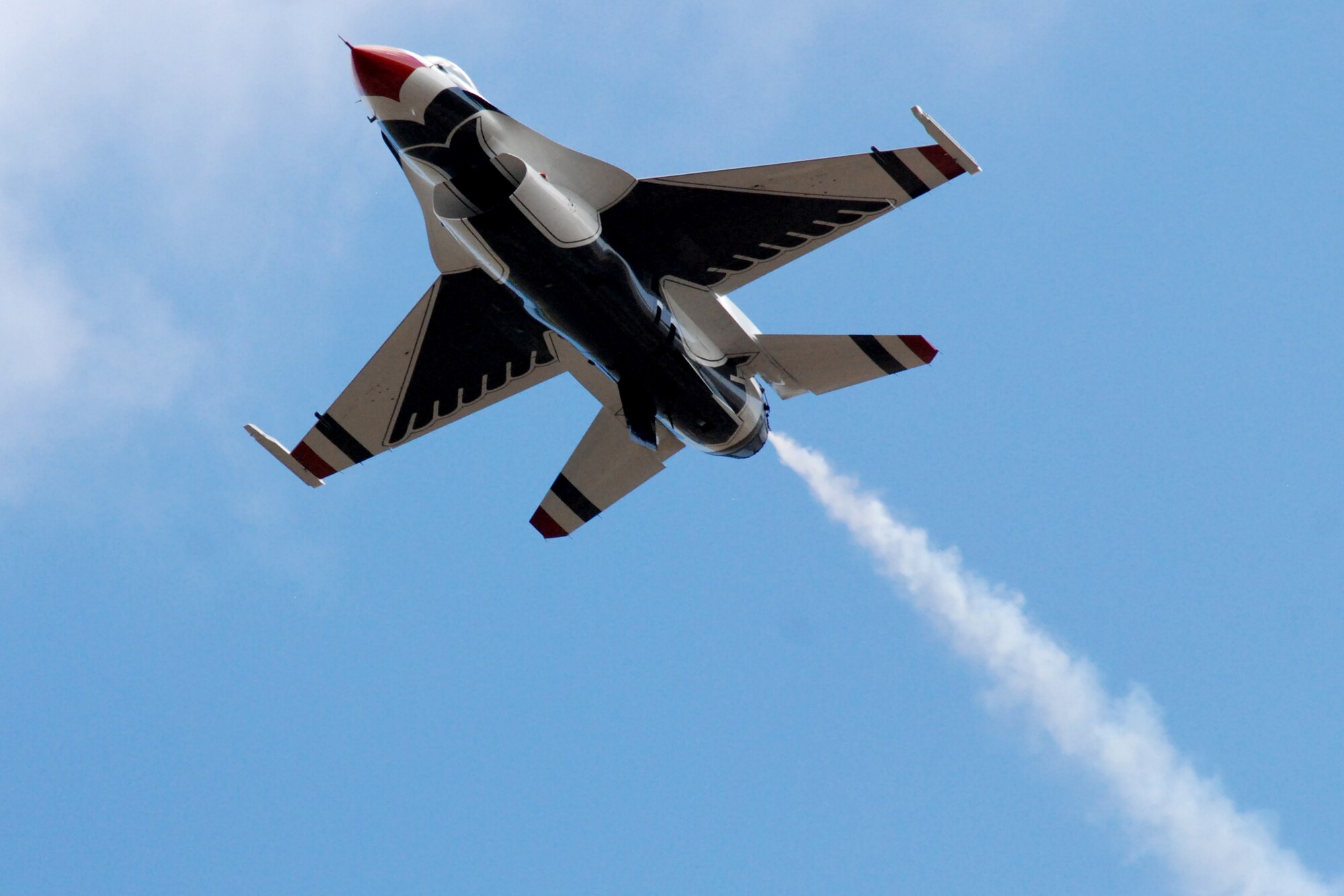 HICKAM AIR FORCE BASE, Hawaii -- The Thunderbirds, U.S. Air Force Demonstration Squadron, practice their performance over Hickam Air Force Base for the "Wings Over the Pacific," Open House Sept. 18. The Thunderbirds demonstrate the capabilities the F-16 Fighting Falcon by performing combat maneuvers during their aerial demonstration. This is Hickam's first open house since 2003, and a crowd of nearly 100,000 paid a visit during the weekend. (U.S. Air Force photo/Staff Sgt. Mike Meares)
