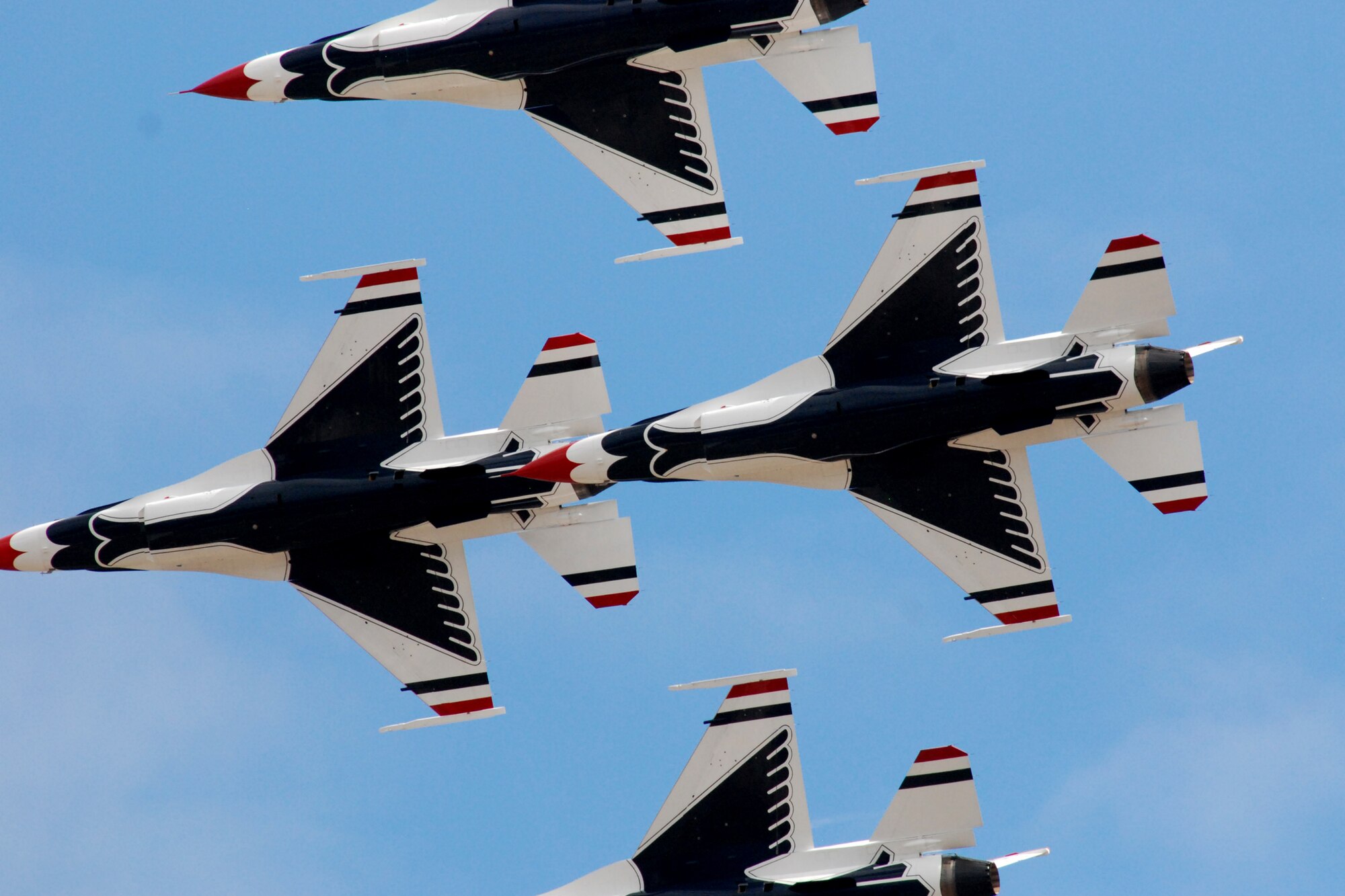 HICKAM AIR FORCE BASE, Hawaii -- The Thunderbirds, U.S. Air Force Demonstration Squadron, practice their performance over Hickam Air Force Base for the "Wings Over the Pacific," Open House Sept. 18. The Thunderbirds demonstrate the capabilities the F-16 Fighting Falcon by performing combat maneuvers during their aerial demonstration. This is Hickam's first open house since 2003, and a crowd of nearly 100,000 paid a visit during the weekend. (U.S. Air Force photo/Staff Sgt. Mike Meares)