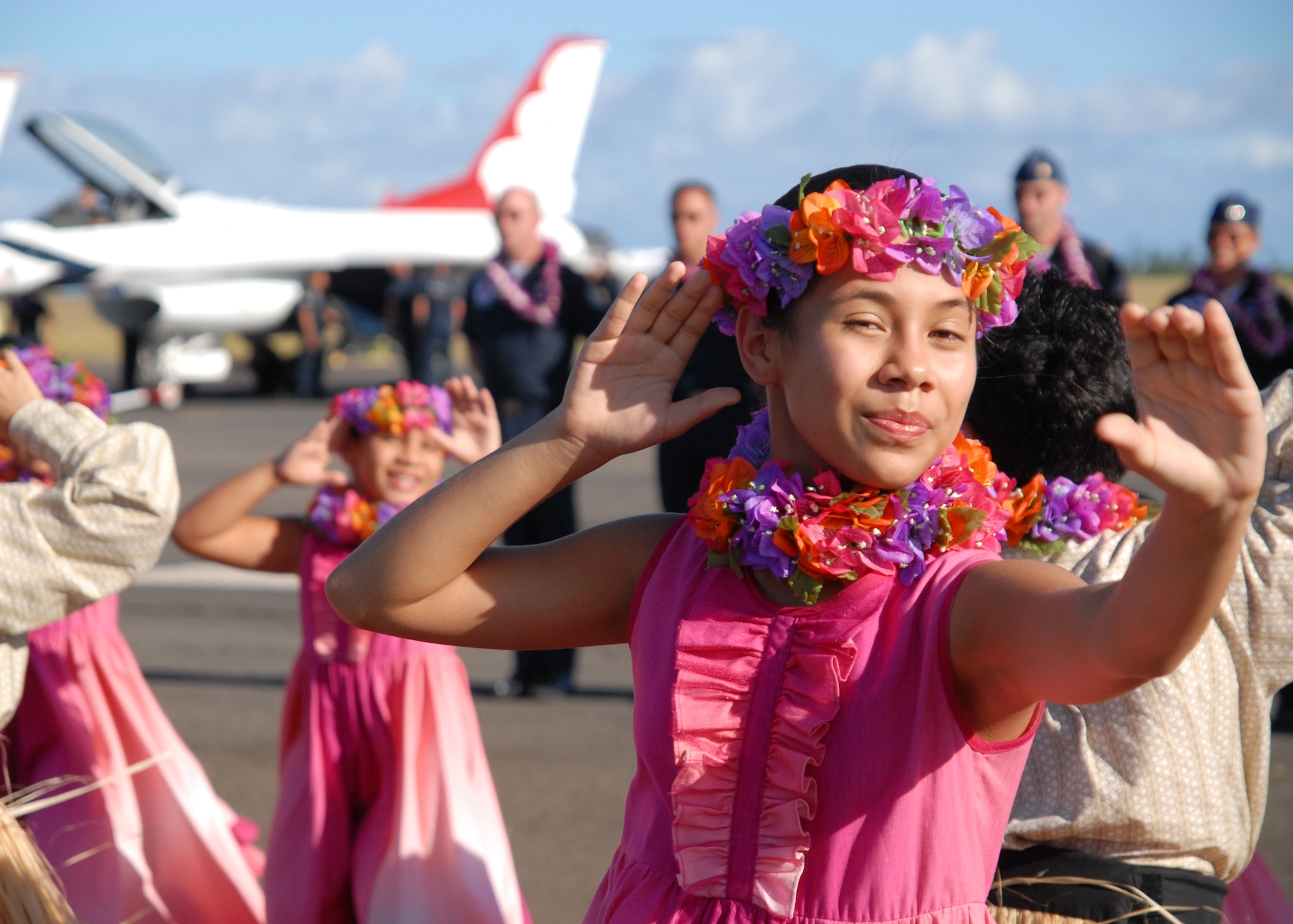 HICKAM AIR FORCE BASE, Hawaii - Children from the Halau Hula Olana under the direction of Kumu Hula Olana dance traditional hula dances for the U.S. Air Force Thunderbirds arrival Sept. 16 here. They met the pilots with leis to put around their necks to welcome them to Hawaii. The lei in the Hawaiian culture symbolizes many things, to include welcome and affection for the person receiving it. In 1975, Howard and Olana A`i established Halau Hula Olana, the School of Living Hula, where hundreds of children ages 6-13 have been instructed by Olana and her family. The halau frequently performs in Hawai`i, and has danced in Europe, Asia, the South Pacific, and across the United States. (U.S Air Force photo/Staff Sgt. Mike Meares)