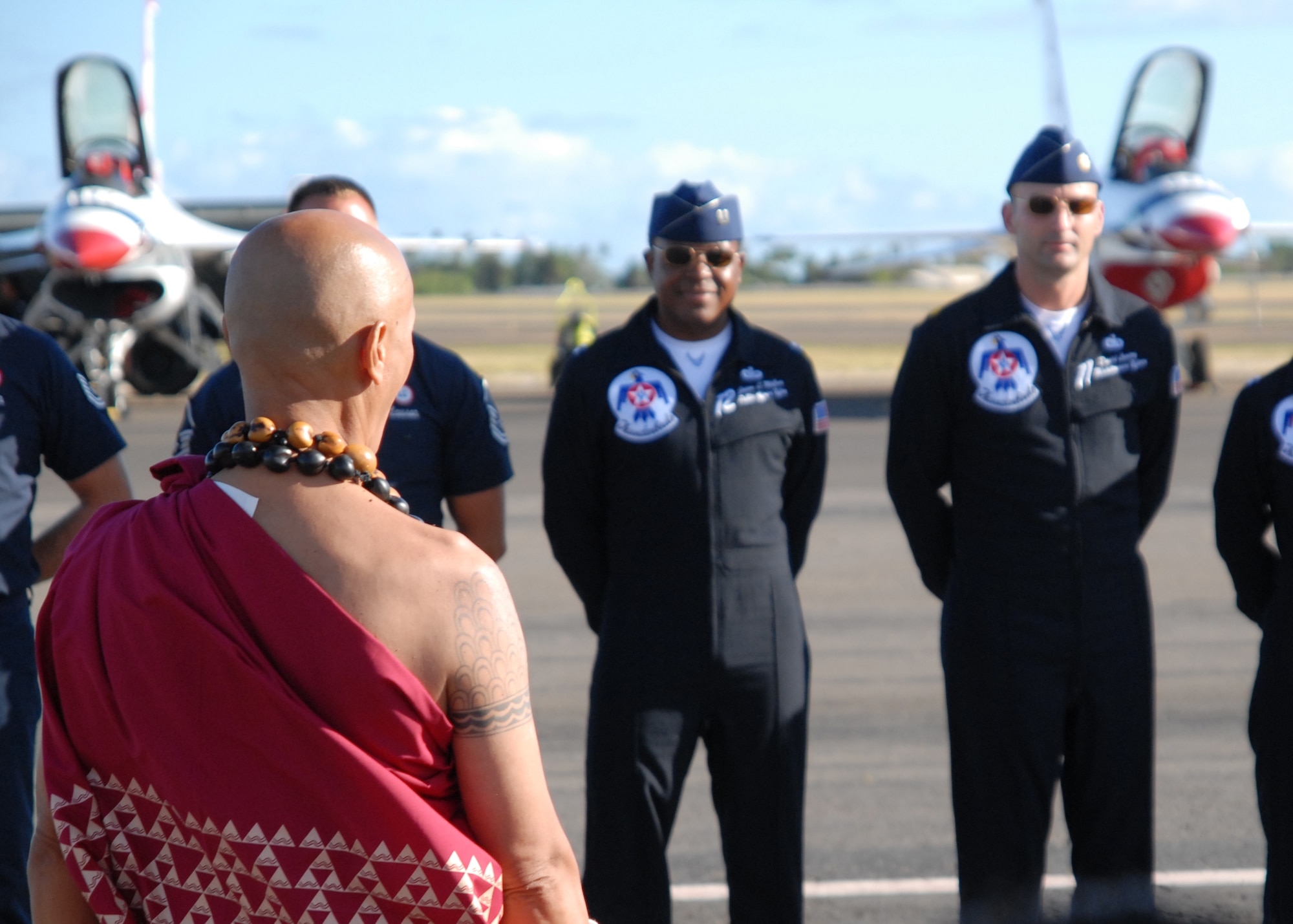 HICKAM AIR FORCE BASE, Hawaii -- Ble Haku Raymond Ganotise, a Hawaiian reverend, sings a traditional oli, or blessing, to the U.S Air Force Thunderbirds Sept. 16 here. He blew on a pu, or conch shell, to traditionally announce their arrival before the blessing.  Ble Haku Ganotise is a retired Hawaii National Guard master sergeant. In Hawaiian the culture, the pu is used to announce the opening of the Hawaii State Legislature, presentation of the royal court at hula festivals and for traditional ceremonies. The pu is also a popular commencement tool at weddings and luaus, and also have been used to honor royalty and famous people. (U.S. Air Force photo/Staff Sgt. Mike Meares)