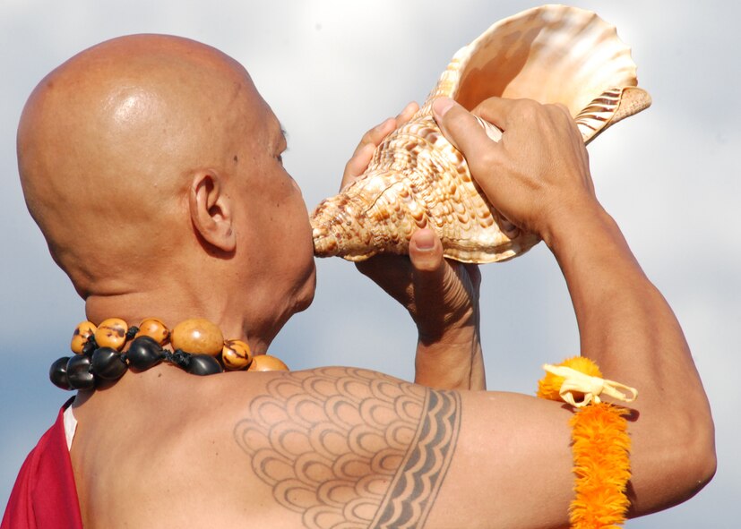 HICKAM AIR FORCE BASE, Hawaii -- Ble Haku Raymond Ganotise, a Hawaiian reverend, blows on a pu, or conch shell, to traditionally announce the arrival of the U.S. Air Force Thunderbirds Sept. 16 here. He then sang a traditional oli, or blessing for the pilots.  Ble Haku Ganotise is a retired Hawaii National Guard master sergeant. In Hawaiian the culture, the pu is used to announce the opening of the Hawaii State Legislature, presentation of the royal court at hula festivals and for traditional ceremonies. The pu is also a popular commencement tool at weddings and luaus, and also have been used to honor royalty and famous people. (U.S. Air Force photo/Staff Sgt. Mike Meares)