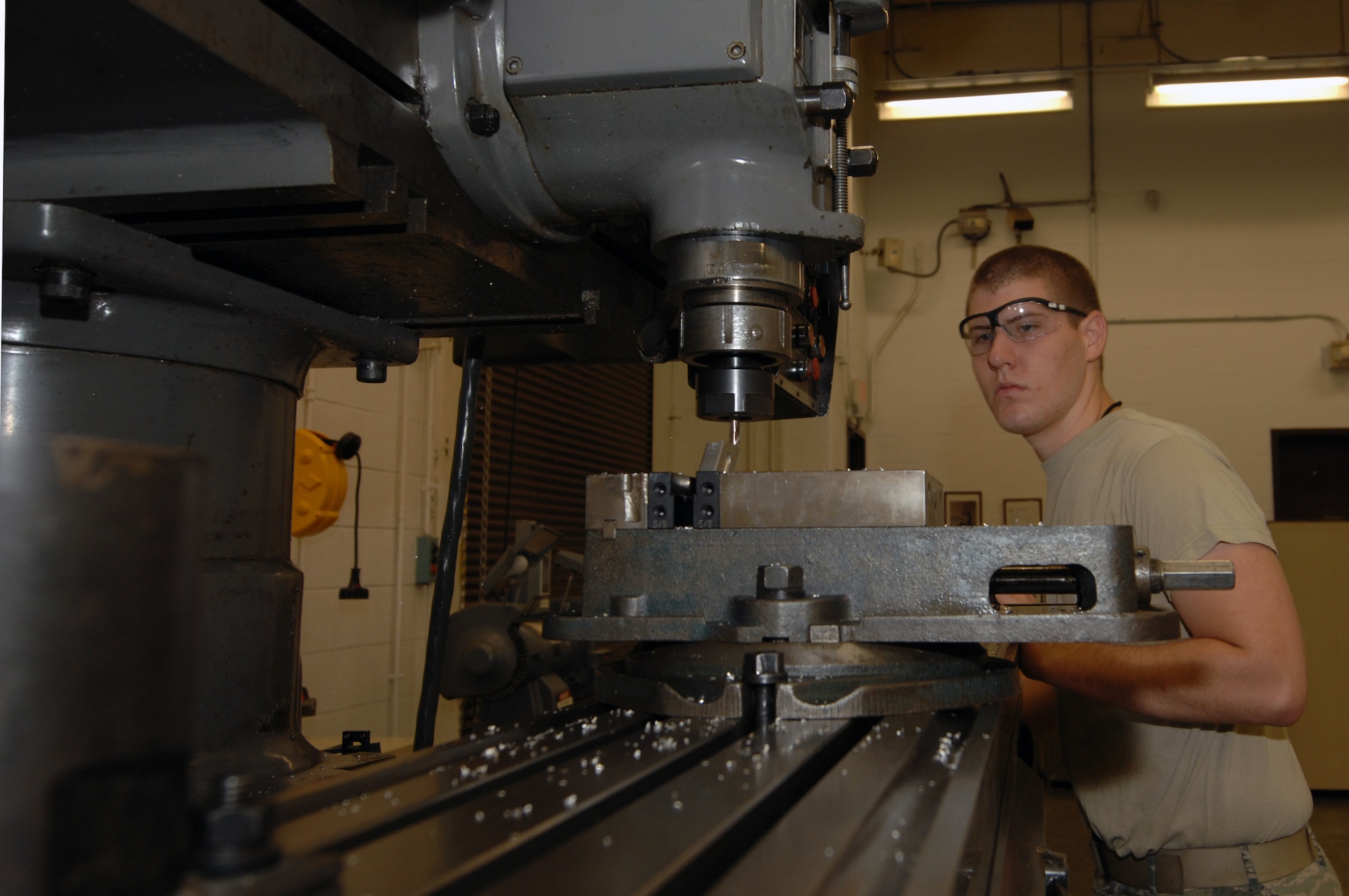 WHITEMAN AIR FORCE BASE, Mo. – Airman 1st Class Craig Scott, Aircraft Metals Technician, 509th Maintenance Squadron, modifies a metal scrapper here today.  Metal technicians are qualified to, but not limited to, perform metals machining, welding and designing machine precision tools or other equipment used to support the mission. (U.S. Air Force photo/Senior Airman Jessica Snow) 