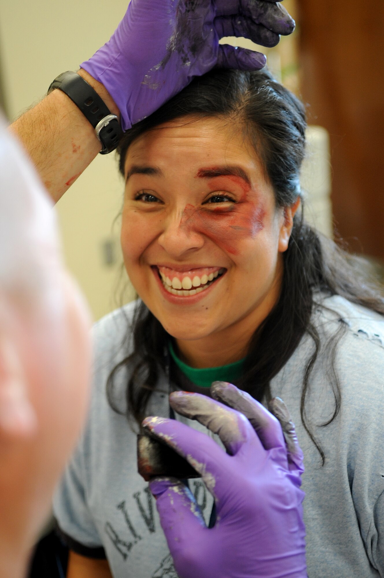 Tech. Sgt. Monica Beller, 460th Mission Support Group, 460th Space Wing, cracks jokes about the role she is portraying during a Medical Emergency Response Capability Assessment and Training (MERCAT), Sept. 18, Buckley Air Force Base, Colo. This training is testing home medical response capabilities. (U.S. Air Force photo by Senior Airman Erika Brooke)