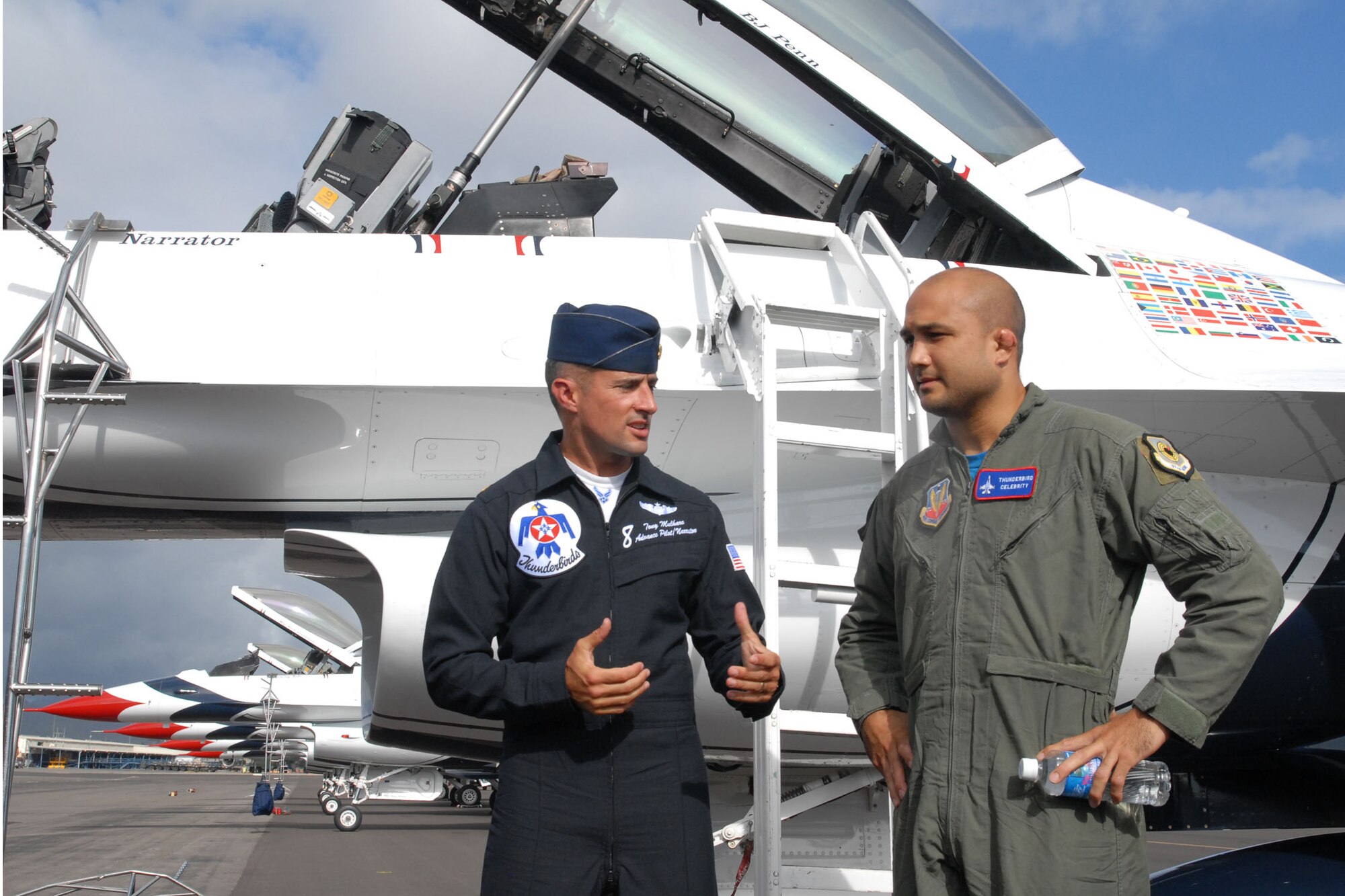 HICKAM AIR FORCE BASE, Hawaii -- Maj. Tony Mulhare, U.S. Air Force Air Demonstration Squadron pilot, speaks with B.J. Penn, Ultimate Fighter Championship Lightweight Champion, after an orientation flight with the Thunderbirds here, Sep. 18. During the flight, they performed ariel combat maneuvers pulling more than nine G's at one point. (U.S. Air Force photo/Staff Sgt. Mike Meares)