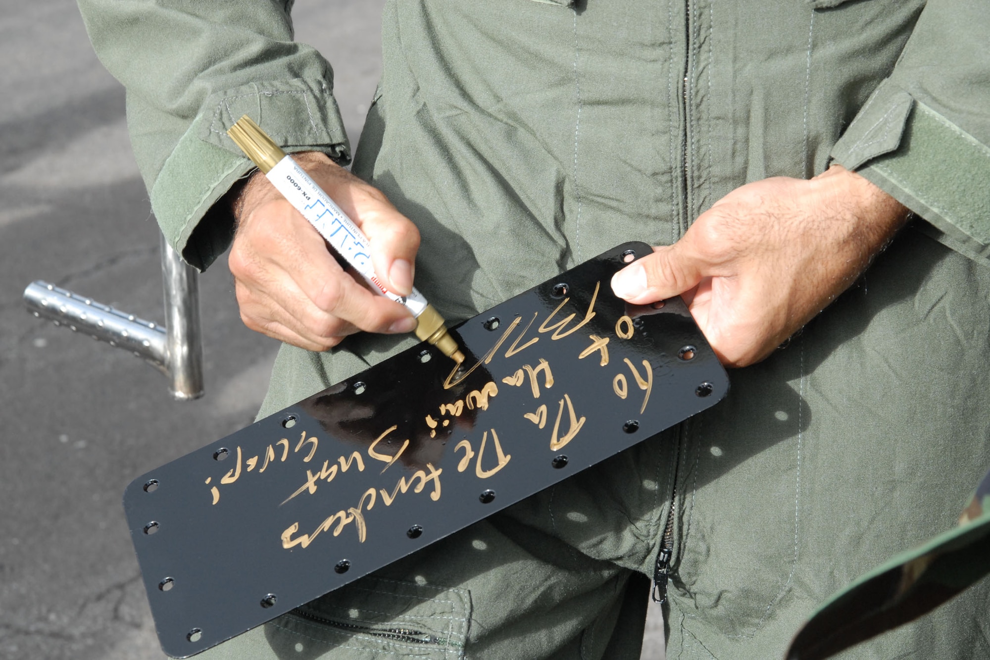 HICKAM AIR FORCE BASE, Hawaii -- B.J. Penn, Ultimate Fighter Championship Lightweight Champion, signs an autograph after his orientation flight with the Thunderbirds, U.S. Air Force Air Demonstration Squadron, here, Sep. 18. During the flight, they performed ariel combat maneuvers pulling more than nine G's at one point. (U.S. Air Force photo/Staff Sgt. Mike Meares)