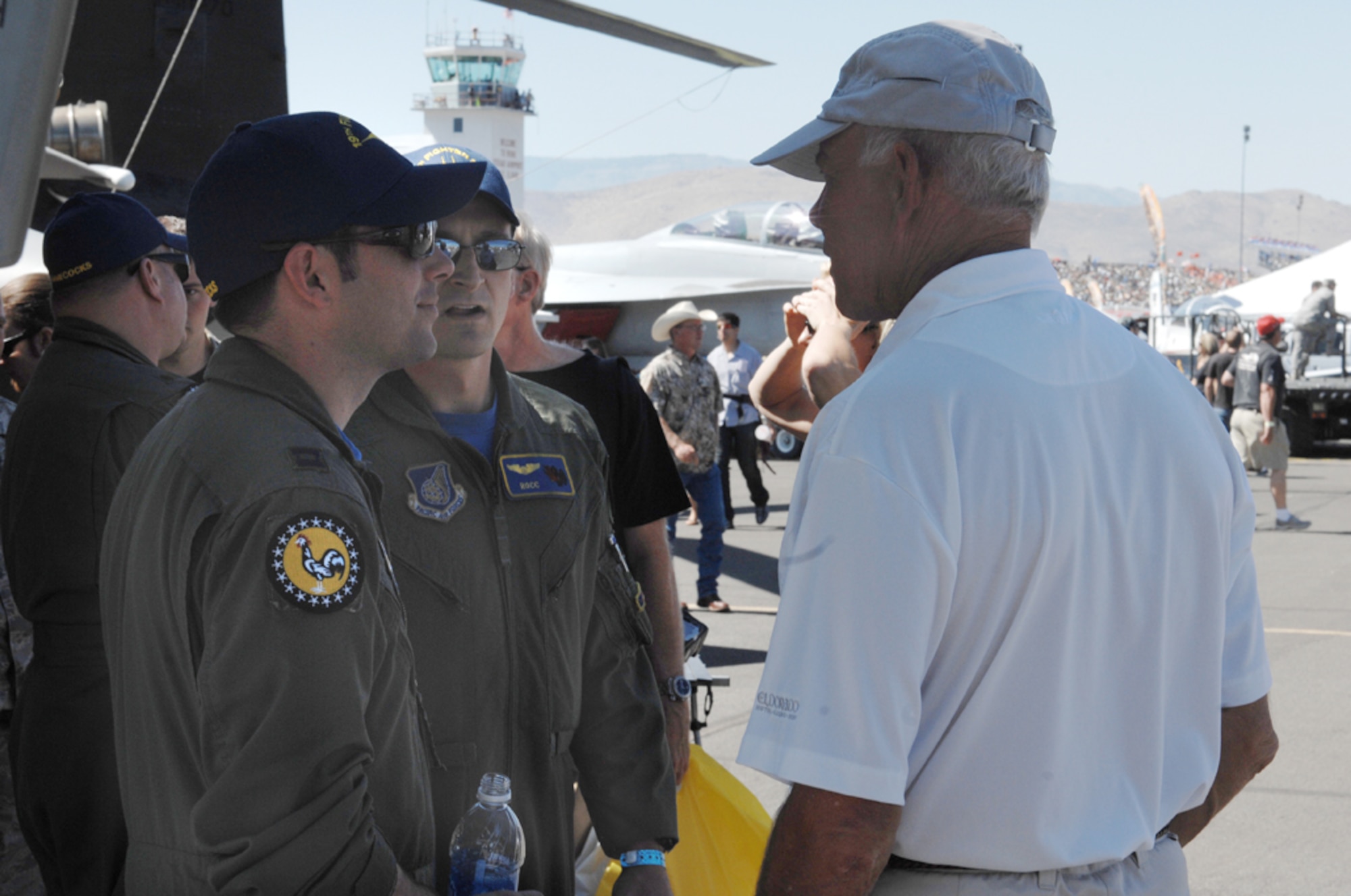 RENO, Nev. -- Capts. Weston Turner and Russell Badowski, 19th Fighter Squadron, answer a spectator's questions about the F-15 at the National Championship Air Races and Air Show Sept. 18-20. Pilots from the 19th FS showcased the F-15, answered questions and educated the public on the role of the F-15 in Alaska during the three-day event. (U.S. Air Force photo/Staff Sgt. Mark Leahy)