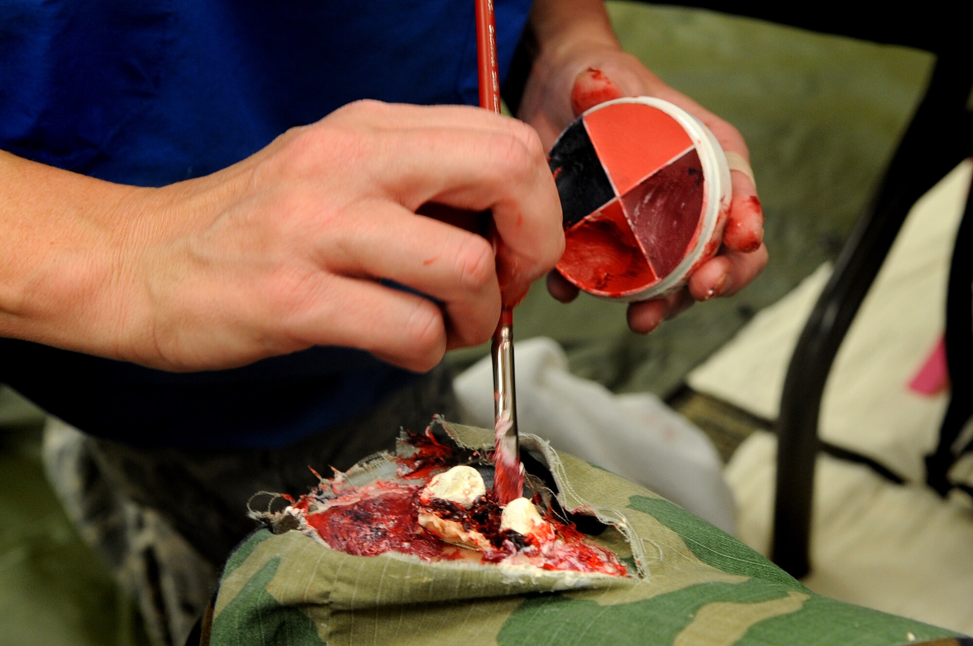A mock patient receives moulage in the form of a mock open-fracture during a MERCAT Sept. 18 at Buckley Air Force Base, Colo. (U.S. Air Force photo by Senior Airman Erika Brooke)