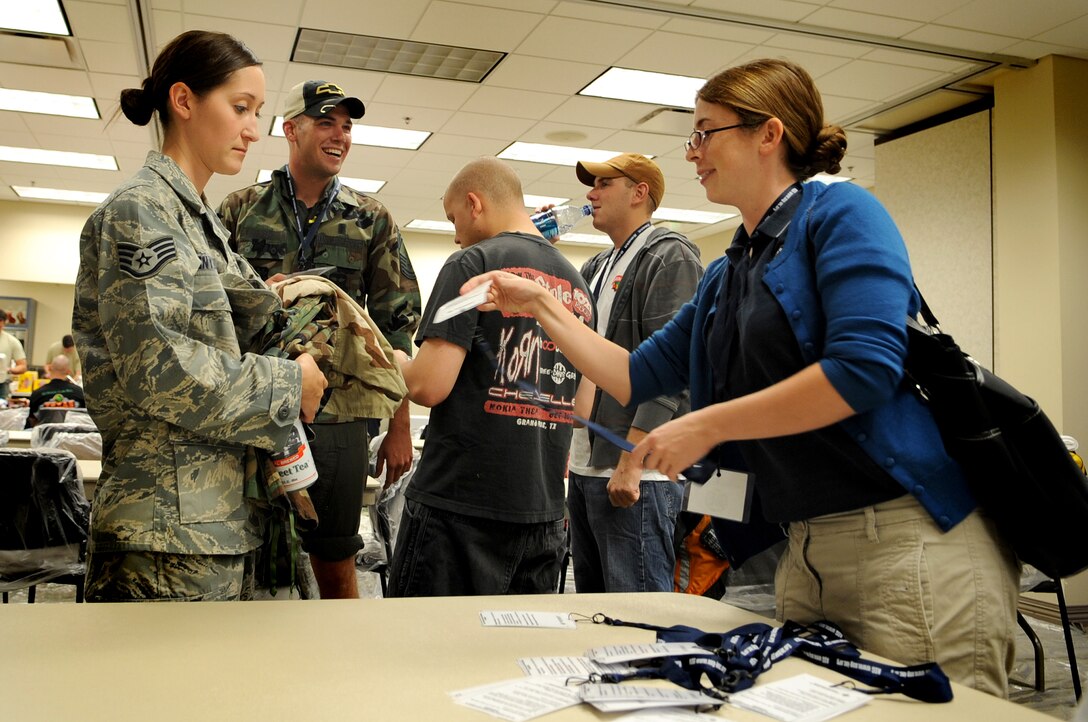 Volunteer mock victims receive “scenario” cards from an Alliane Solution Group representative prior to being moulaged for a MERCAT, Sept. 18 at Buckley Air Force Base, Colo. (U.S. Air Force photo by Senior Airman Erika Brooke)