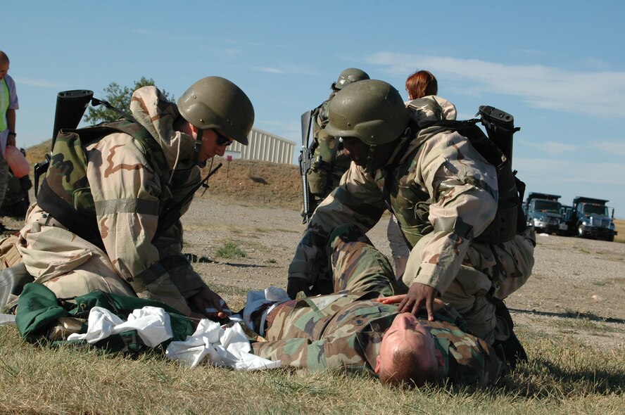 Tech. Sgt. Sarah Edwards, 341st Medical Operations Squadron medical technician, gives feedback to Airmen after treating simulated injuries during a Self Aid and Buddy Care exercise Sept. 17 at Camp Grizzly. (U.S. Air Force photo/Senior Airman Dillon White)