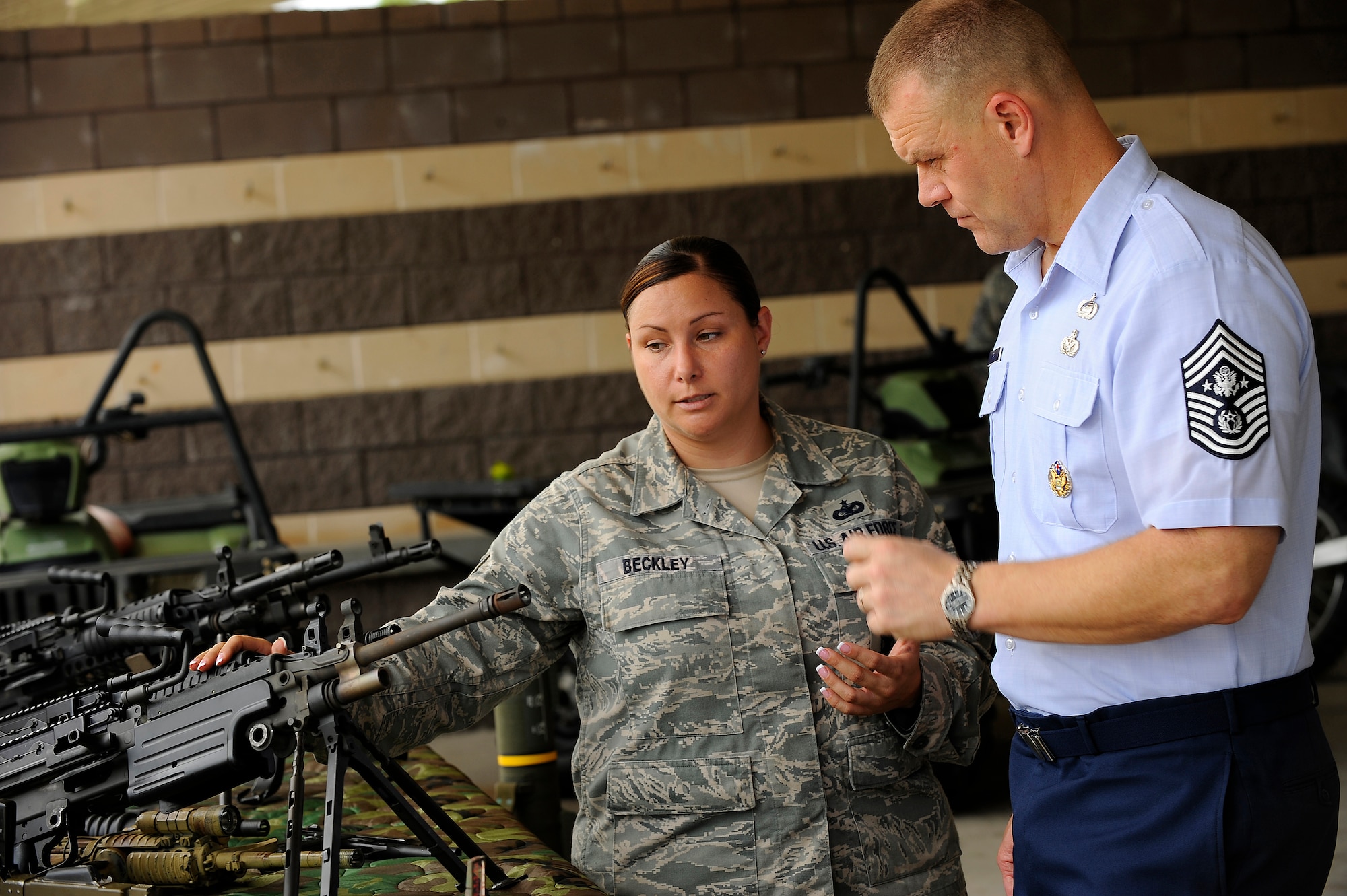 U.S. Air Force Tech. Sgt. Elizabeth Beckley, Special Tactics Training Squadron, explains the difference between the M249 automatic rifle and the MK46 light machine gun to Chief Master Sergeant of the Air Force James A. Roy Sept. 21, 2009, at Hurlburt Field, Fla. (U.S. Air Force photo by Senior Airman Jason Epley/Released)