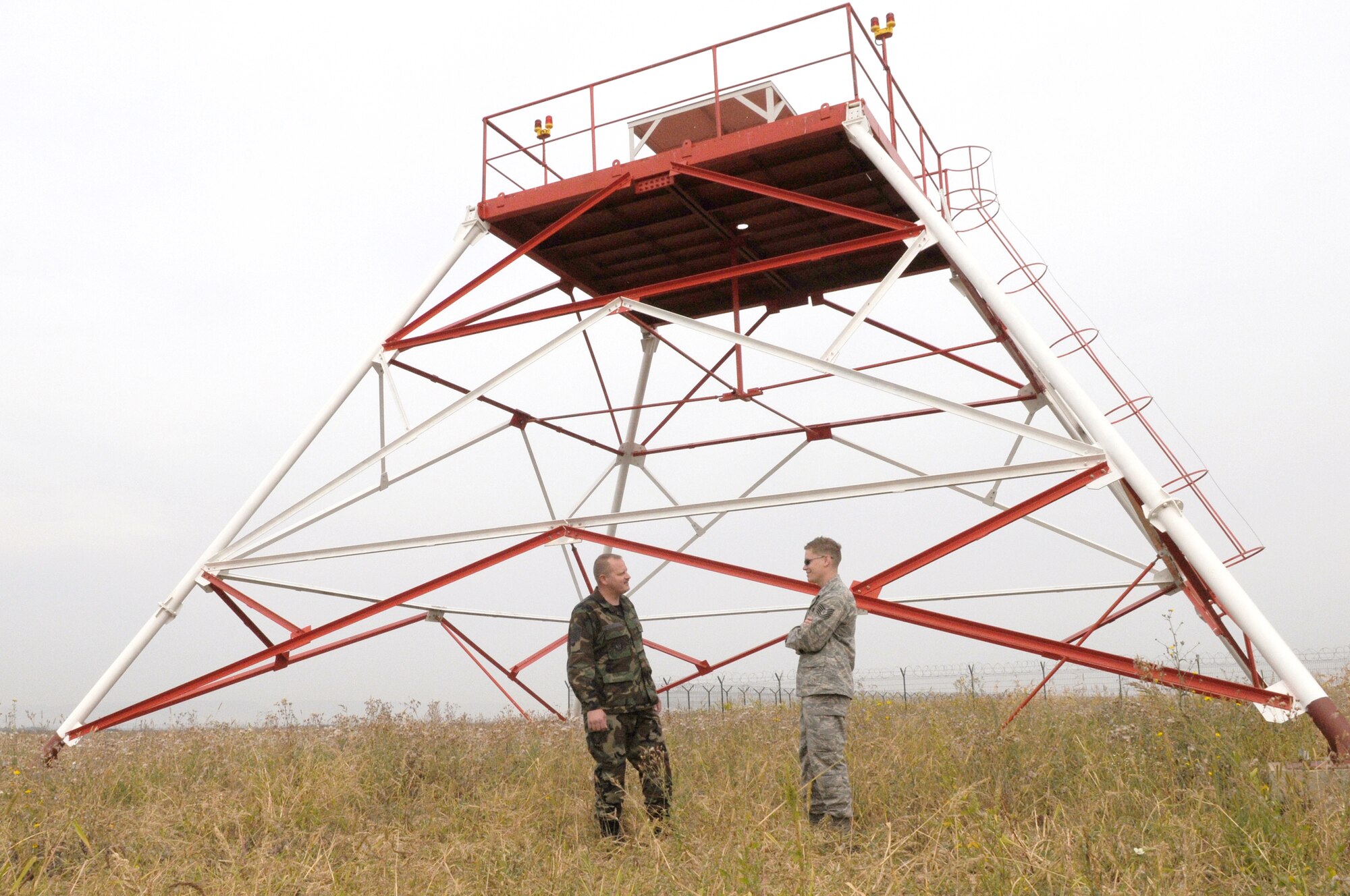 Master Sgt. Jerry McDonald and Tech. Sgt. Aaron Tibbits discuss what is needed for the installation of the tactical air navigation system during the final site inspection Sept. 17, 2009, Camp Turzii, Romania. The installation of the TACAN will provide better communication capabilities between the air and ground forces in the area, and it will also help strengthen the bonds between the United States and the host nation. Sergeants McDonald and Tibbits are 1st Communications Maintenance Squadron special communications team members. (U.S. Air Force photo/Airman 1st Class Alexandria Mosness) 
