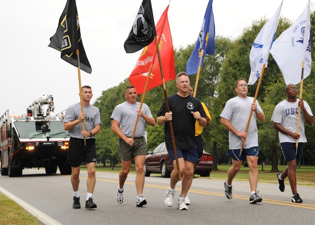 Chief Master Sgt. Mike Ivey runs down Hill Boulevard during the final leg of a 24-hour vigil run alongside members of the Army, Marine Corps, Navy and Coast Guard here Sept. 18. The run included participants from various squadrons on the base and was held to honor prisoners of war and those listed as missing in action. Chief Ivey is the 437th Airlift Wing command chief. (U.S. Air Force photo/Senior Airman Katie Gieratz)