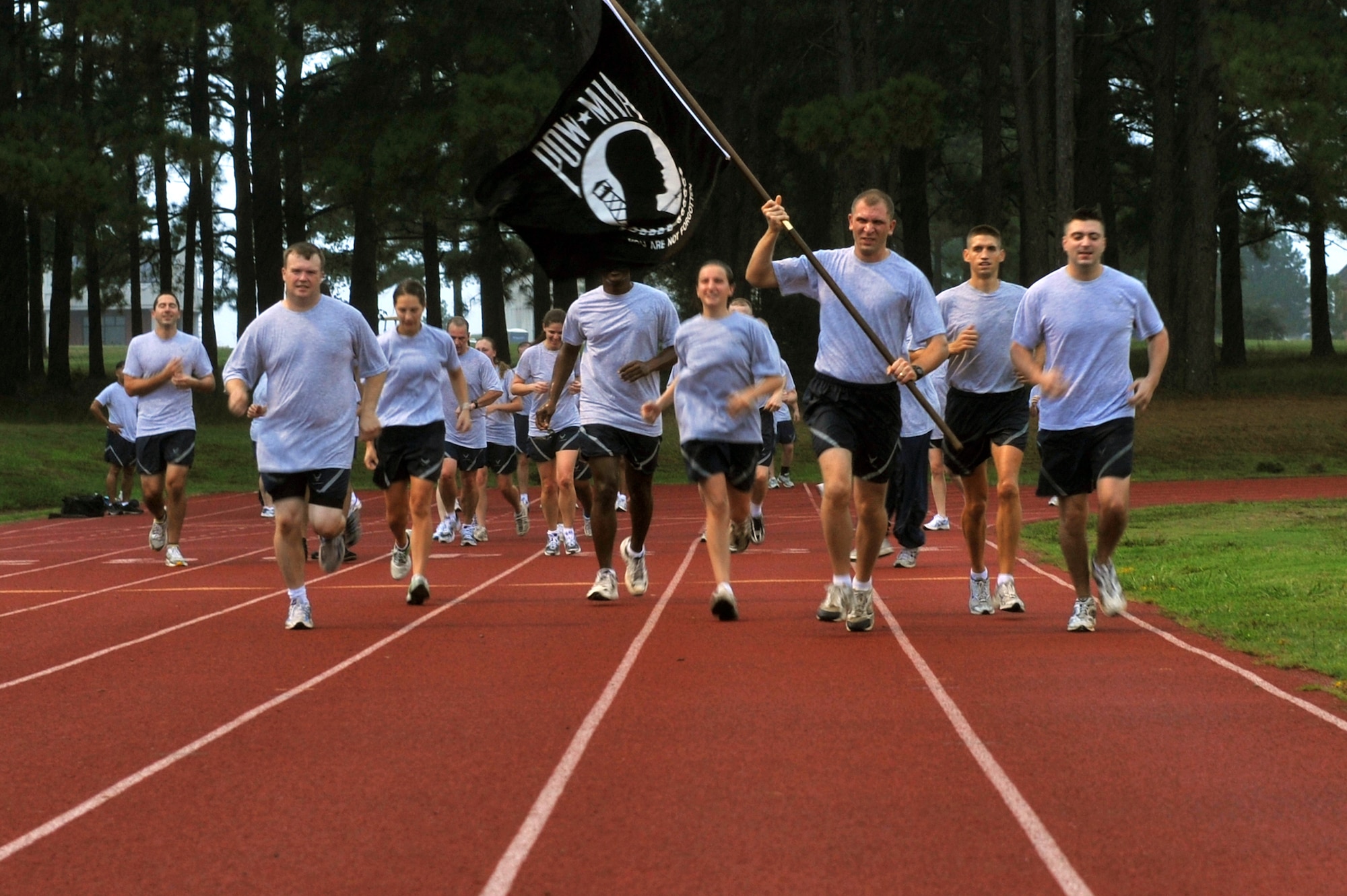 Captain Joseph Knable, 19th Airlift Wing Public Affairs deputy officer, leads the POW/MIA guide-on with several other members from the 19th AW Director of Staff Agency.  The wing honored all POW/MIA's by conducting a 24 hour fun-run while keeping the POW/MIA guide-on in constant motion for the duration of the run. (US Air Force Photo by Staff Sgt. Richard Pagan)