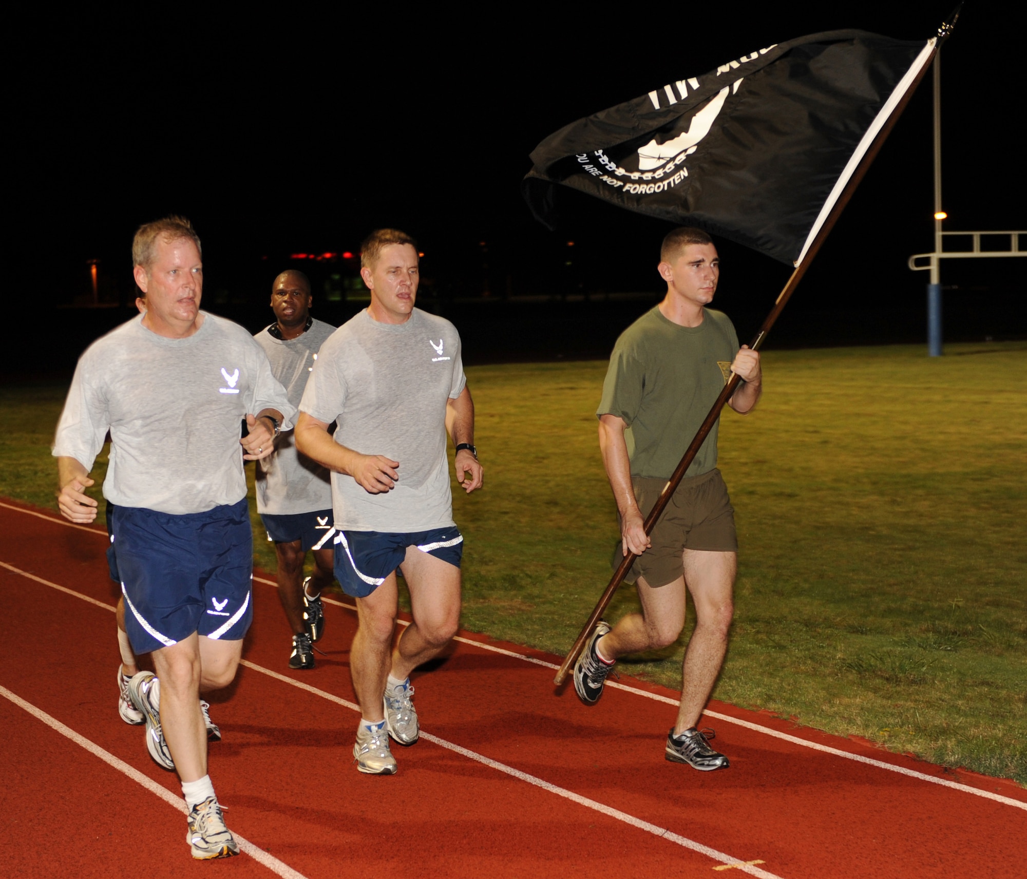 Col. Mike Zick, 19th Airlift Wing vice commander, along with Col. Kirk Lear, 314th Airlift Wing vice commander, leads the POW/MIA run on base Sept. 19. The base held a 24-hour run in honor of the POW/MIA's in which the POW/MIA flag was passed on from unit to unit for the duration of the run. (US Air Force photo by Senior Airman Jim Araos)