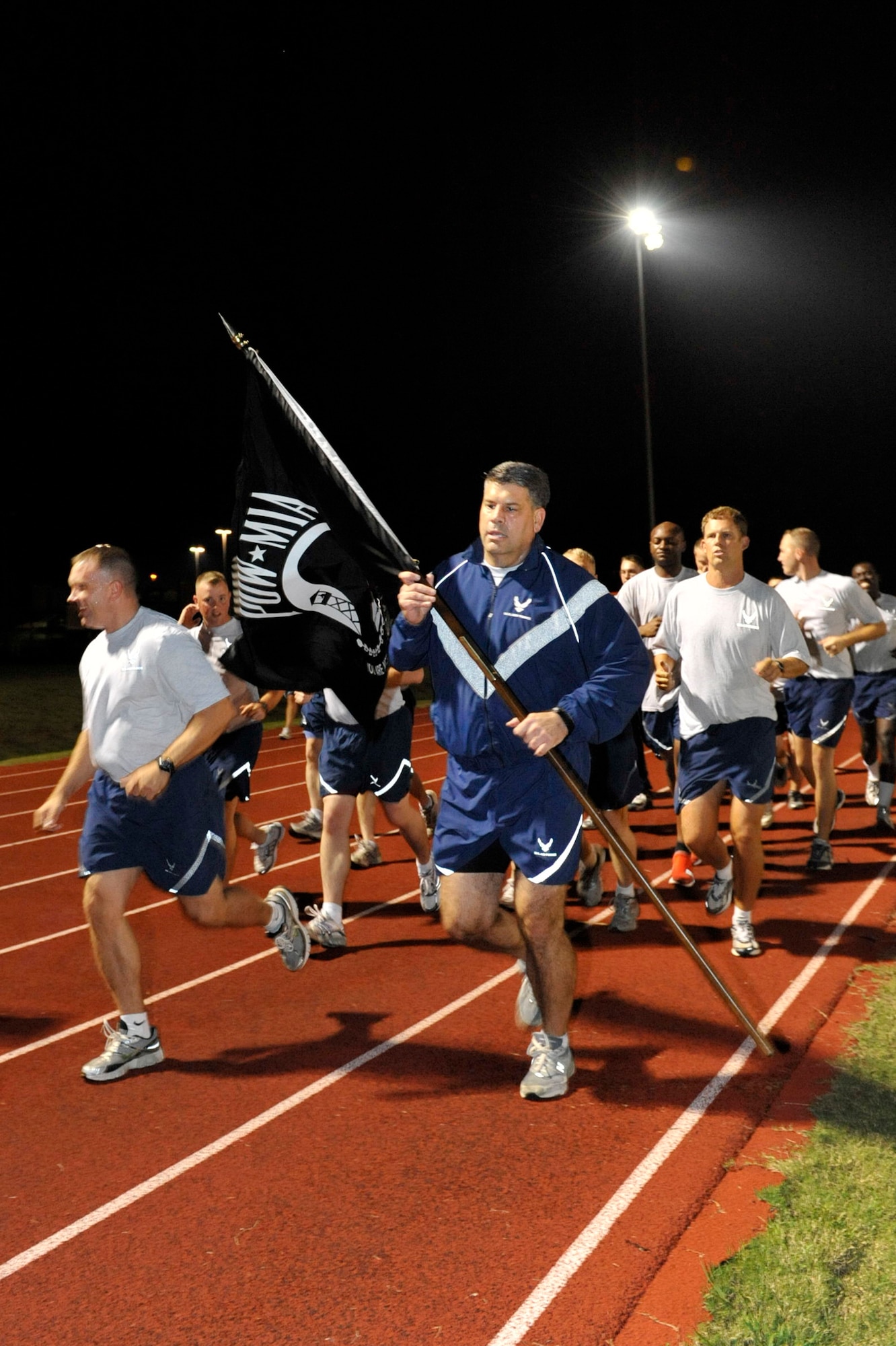 Col. Greg Otey, 19th Airlift Wing commander, leads the way during the Prisoner of War/Missing in Action run Sept 18. In honor of the POW/MIA, the run lasted 24 hours with the flag continuously carried by Little Rock Air Force base members. (U.S. Air Force photo by Airman 1st Class Lausanne Pacheco)
