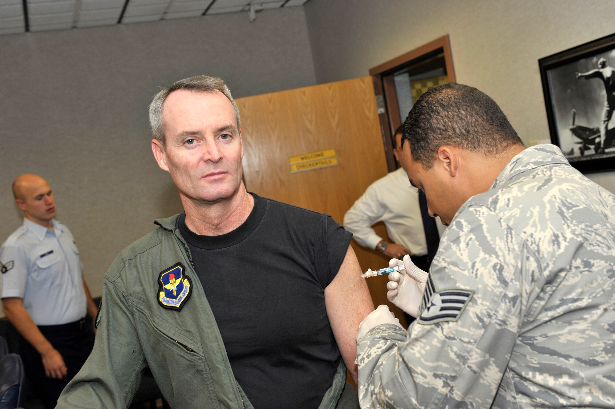 Brig. Gen. Darryl Roberson, 325th Fighter Wing commander, receives a standard flu shot Sept. 21, administered by Staff Sgt. Michael Sousa, 325th Medical Squadron aerospace medical technician.  The seasonal flu shot is being given out via mobile visits to active-duty personnel.  The next squadron to receive the flu shot will be 2nd Aircraft Maintenance Unit on Oct. 2.  (U.S. Air Force photo/Jonathan Gibson)   
