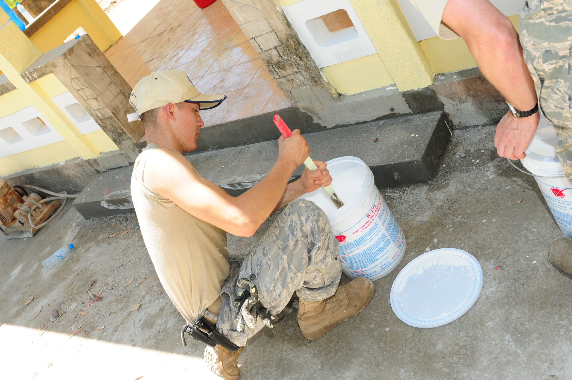 Airman 1st Class George Perez, a civil engineer technician from Elmendorf Air Force Base, Alaska, mixes paint for the exterior of the Cam Thuy Medical Clinic in Quang Tri Province, Vietnam, on Sept. 16.  Airman Perez and other Airmen are participating in Operation Pacific Angel 2009 Sept. 15 to 24 to provide humanitarian assistance in cooperation with local authorities to Quang Tri Province residents. Pacific Angel is a Pacific Air Forces operation led by 13th Air Force at Hickam Air Force Base, Hawaii. The joint and combined humanitarian assistance operation is conducted in the Pacific area of responsibility to support U.S. Pacific Command’s capacity-building efforts. (U.S. Air Force photo/Tech. Sgt. Kerry Jackson)