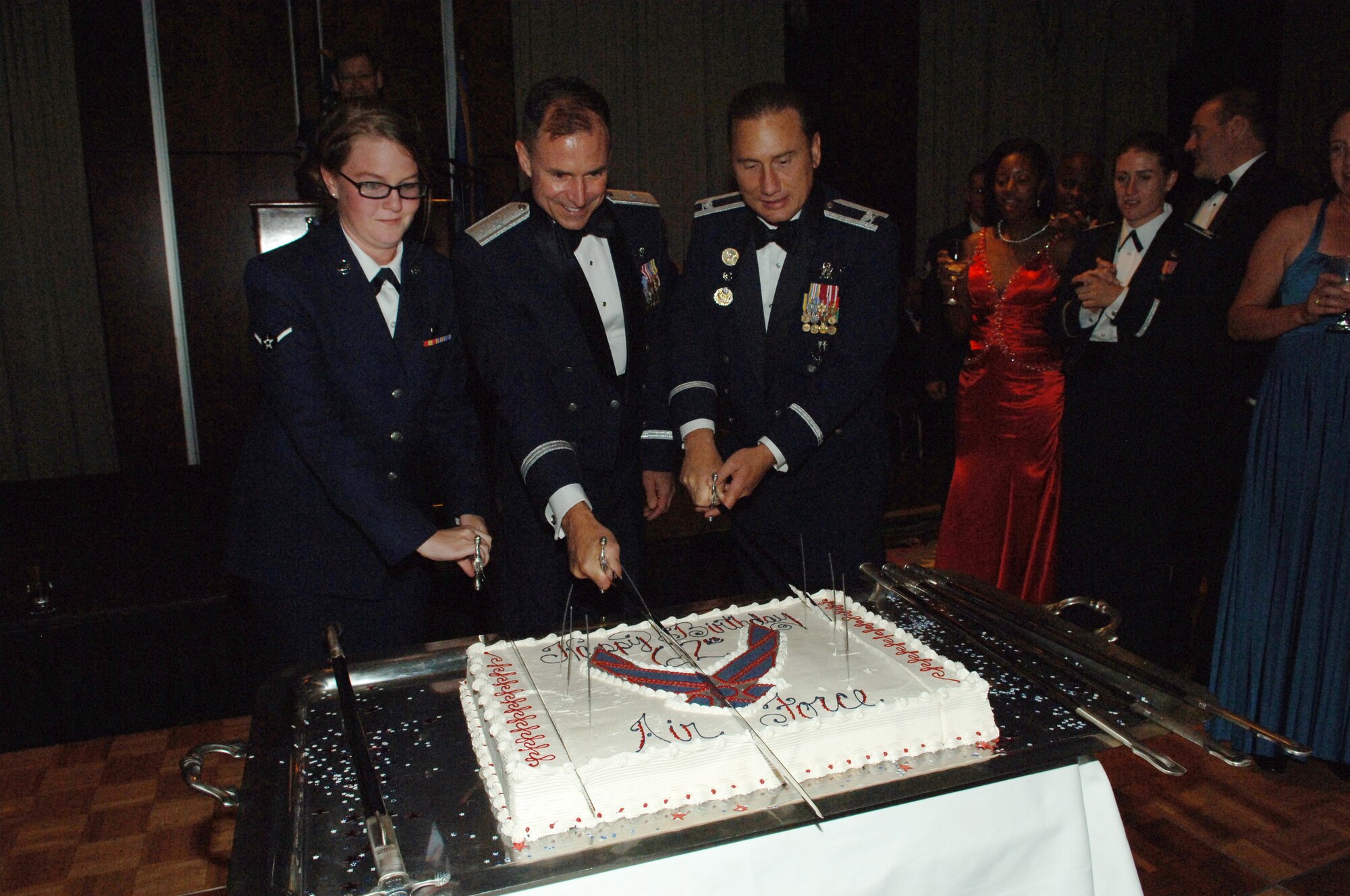 Airman Samantha Sharp, 460th Force Support Squadron, Brig. Gen. Kevin Pottinger, ARPC commander, and Col. Clint Crosier, 460th Space Wing commander, cut the Air Force birthday cake at the ball. (U.S. Air Force photo by Tech. Sgt. Shirley Henderson)