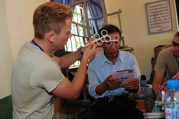 Maj. (Dr.) Steven Tittl, an optometrist assigned to the 439th Aerospace Medicine Squadron at Westover Air Reserve Base, Mass., examines the eyes of a Vietnamese man Sept. 18 in Quang Tri Province, Vietnam. Doctor Tittl and other Air Force members are participating in Operation Pacific Angel 2009 Sept. 15-24, providing humanitarian assistance in cooperation with local authorities to Quang Tri Province residents. Pacific Angel is a Pacific Air Forces operation led by 13th Air Force at Hickam Air Force Base, Hawaii. The joint and combined humanitarian assistance operation is conducted in the Pacific area of responsibility to support U.S. Pacific Command’s capacity-building efforts. (U.S. Air Force photo/Tech. Sgt. Kerry Jackson) 