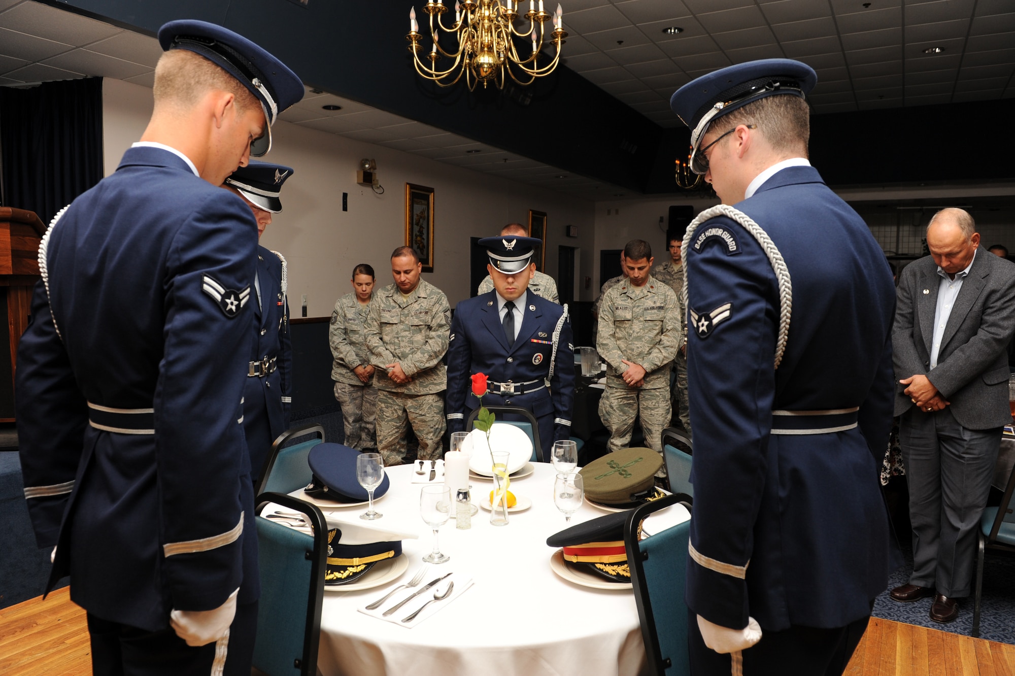 Little Rock Air Force Base honor guardsmen, stand at attention at Hangar 1080 on base Sept. 18 at the POW/MIA table in honor of the nation's military members who were POWs or still missing in action. (US Air Force photo by Senior Airman Ethan Morgan)