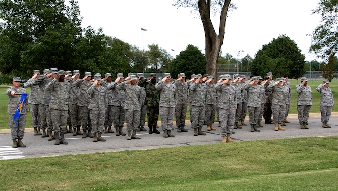 A formation of Team Vance members salute during the playing of the national anthem, part of the POW/MIA Recognition Day retreat ceremony held at the base flag pole on Vance AFB, Okla., Sept. 18. (U.S. Air Force photo/ Terry Wasson)