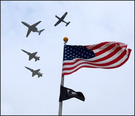 Four trainer aircraft assigned to the Flying Training Squadrons on base – a T-1A Jayhawk, a T-6A Texan II and two T-38 Talons -- perform a flyby over the flag pole during the POW/MIA Recognition Day retreat ceremony at Vance AFB, Okla., Sept. 18. (U.S. Air Force photo/ Terry Wasson)