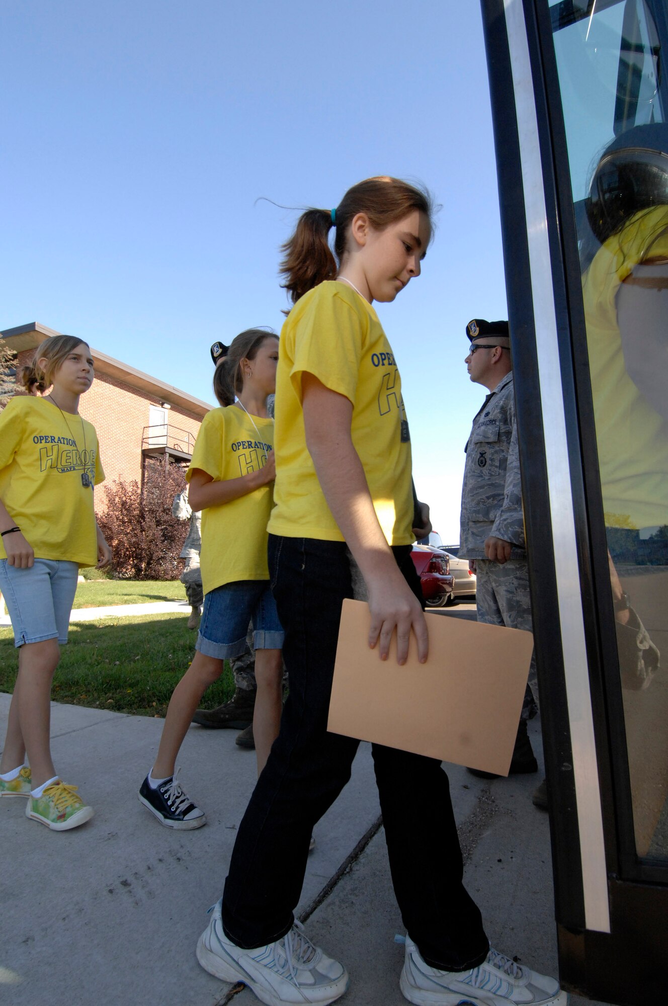 MINOT AIR FORCE BASE, N.D. -- Participants in Operation Heroes board a bus to be taken out to a “special mission” here, Sept. 19.  Operations Heroes is an event for children to go through a mock deployment to simulate what their parents goes through when preparing to deploy. The older children went on a “special mission” where they learned military formation and how to detain suspects. (U.S. Air Force Photo by Senior Airman Matthew Smith)  