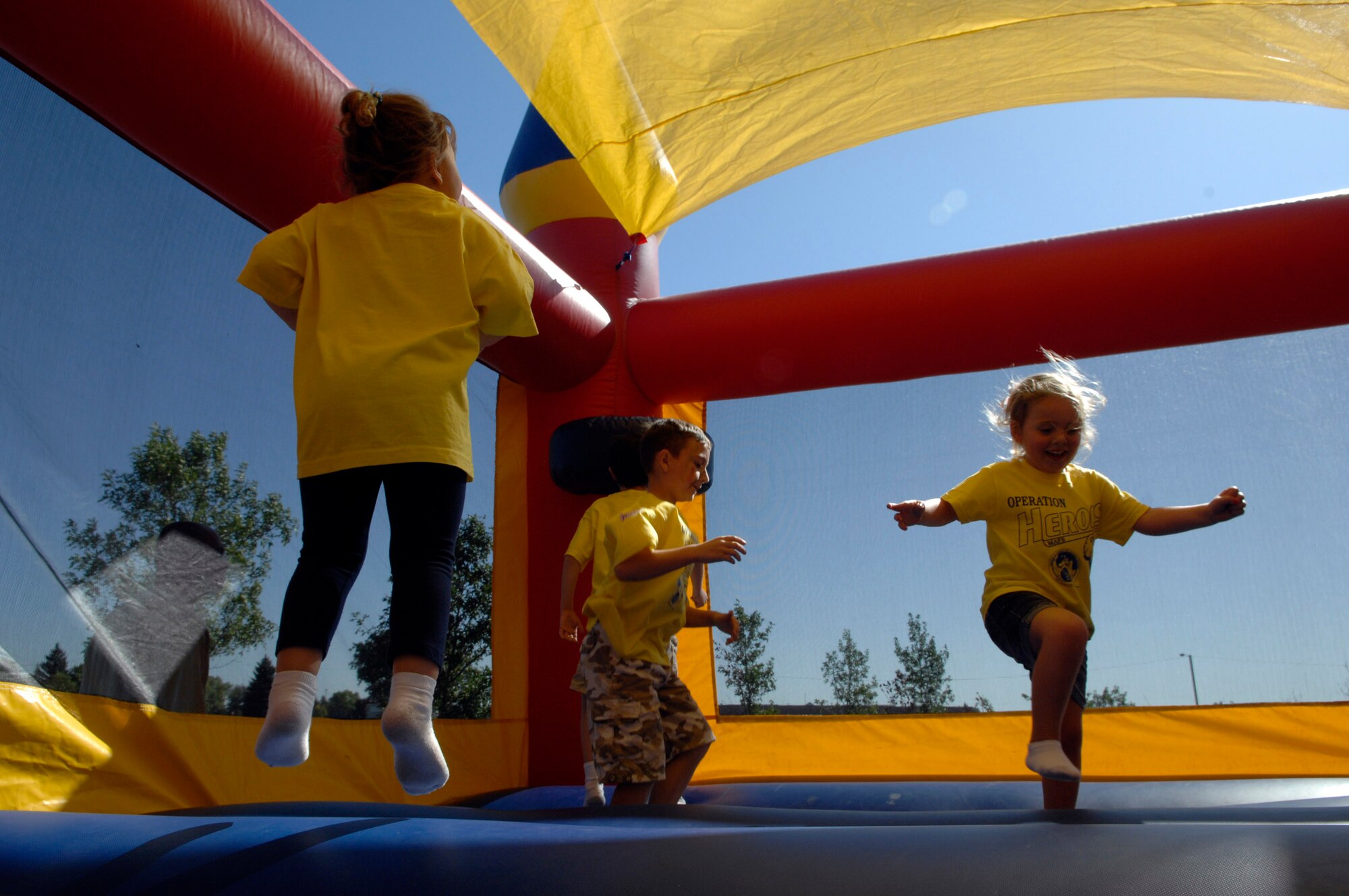 MINOT AIR FORCE BASE, N.D. -- Children jump around in the bounce house during Operations Heroes here, Sept. 19.  Operations Heroes is an event for children to go through a mock deployment to simulate what their parents goes through when preparing to deploy. (U.S. Air Force Photo by Senior Airman Matthew Smith) 