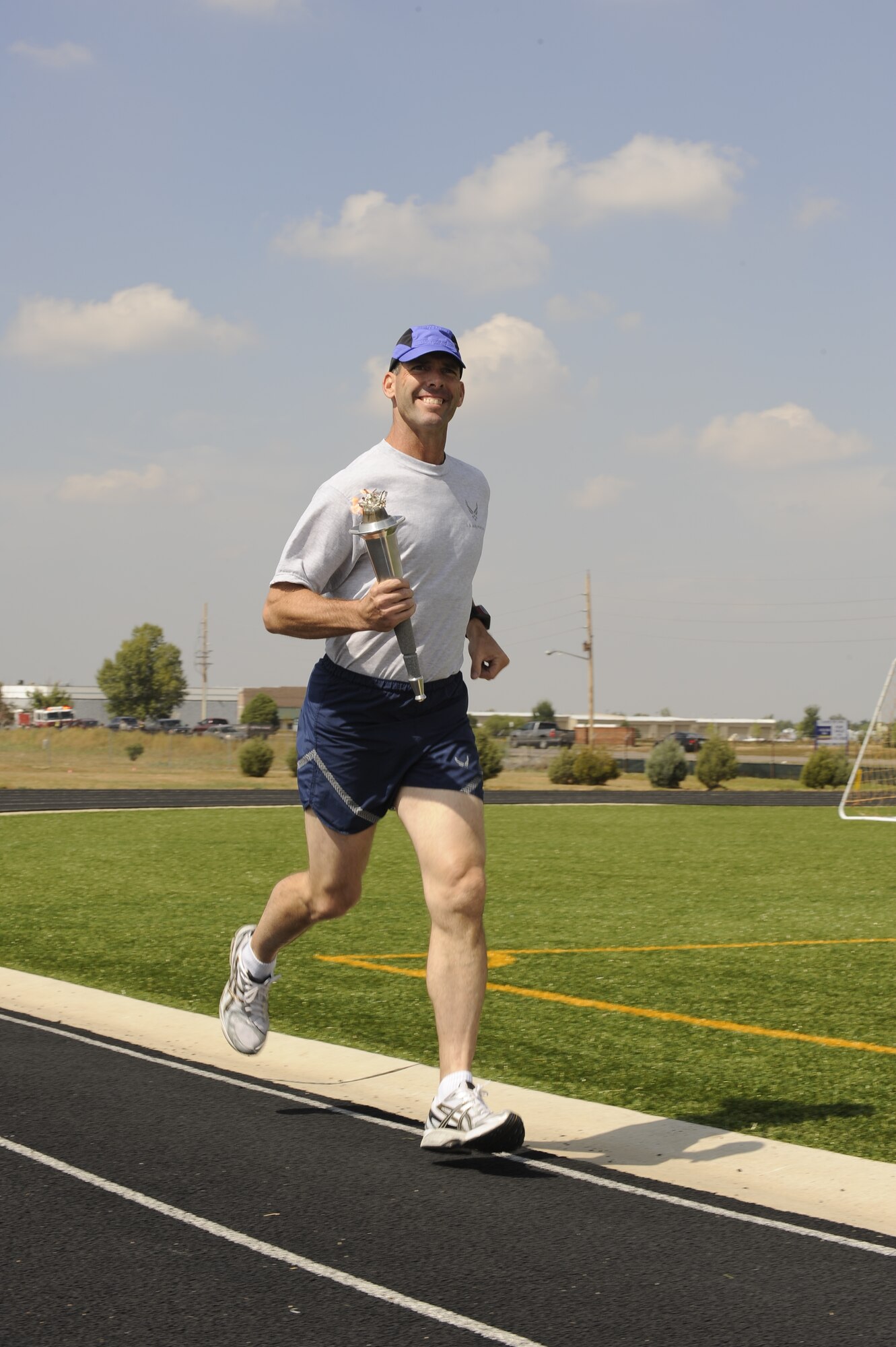 Chief Master Sgt. Todd Kennedy, 460th Space Communications Squadron, kicks off the torch run for Team Buckley during the POW/MIA torch run held at the base track, Sept. 18. (U.S. Air Force photo by Senior Airman Steven Czyz)