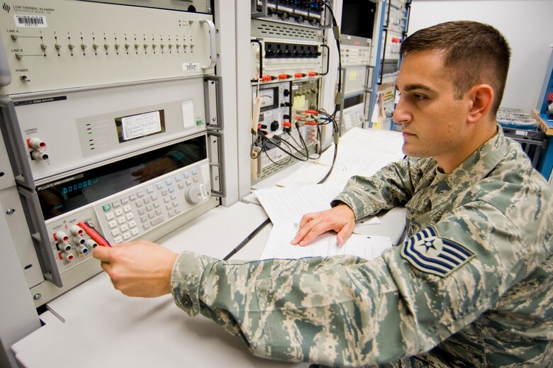 Tech. Sgt. Eric Rozzano, 62nd MXS, calibrates a voltage standard. (U.S. Air Force photo/Abner Guzman)