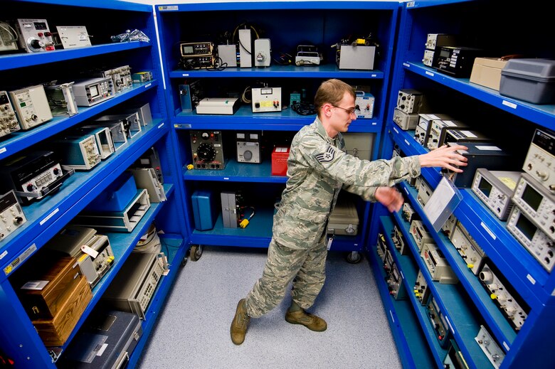 Senior Airman Gregory Olsen, 62nd MXS, organizes test equipment in the Waveform Generation and Analysis section of the lab. (U.S. Air Force photo/Abner Guzman)